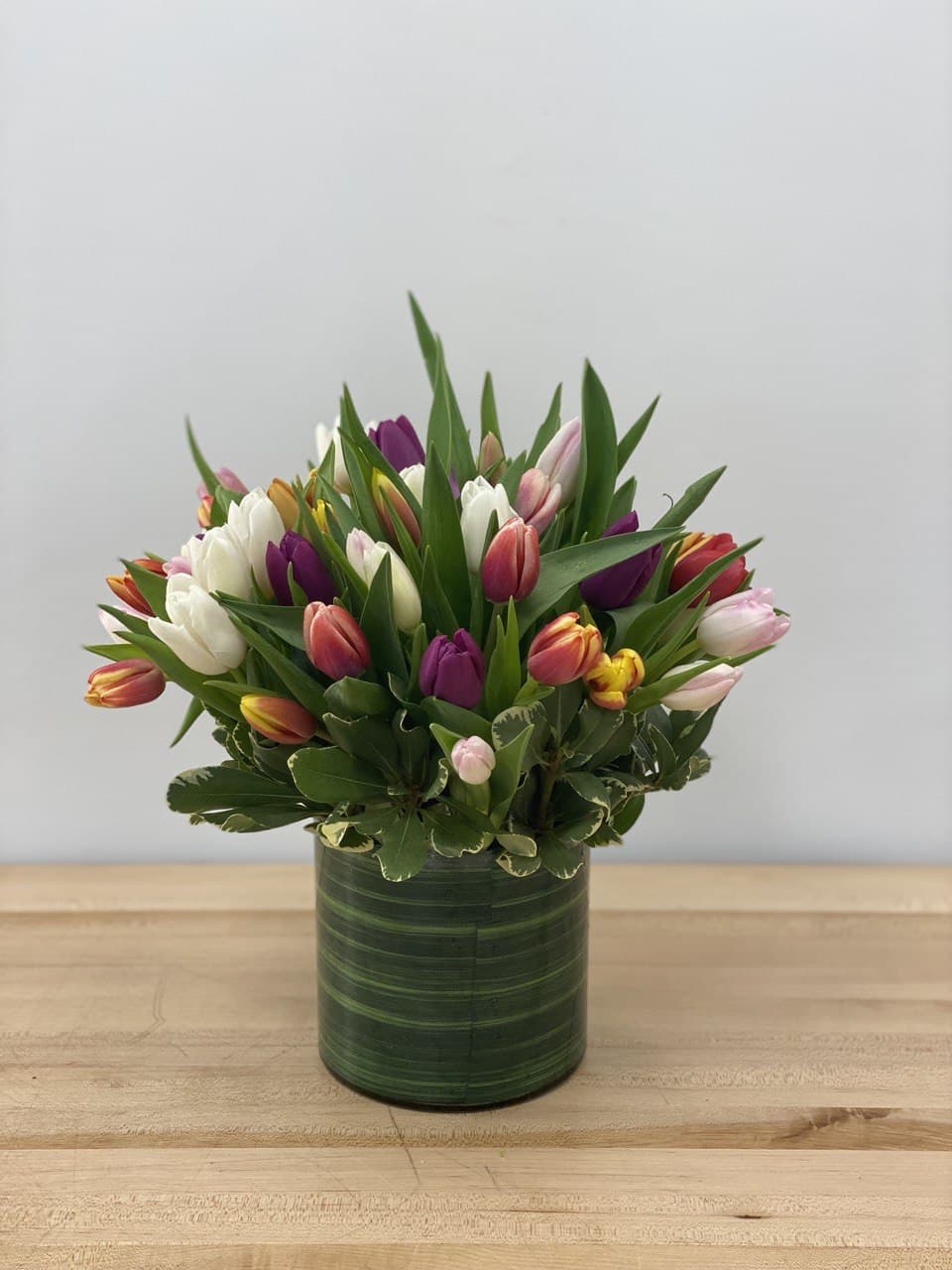 Tulip Passion - Colorful tulips nicely arranged in a 6&quot; clear cylinder, simply outstanding, perfect for any occasion! This arrangement includes 40 stems of tulips.