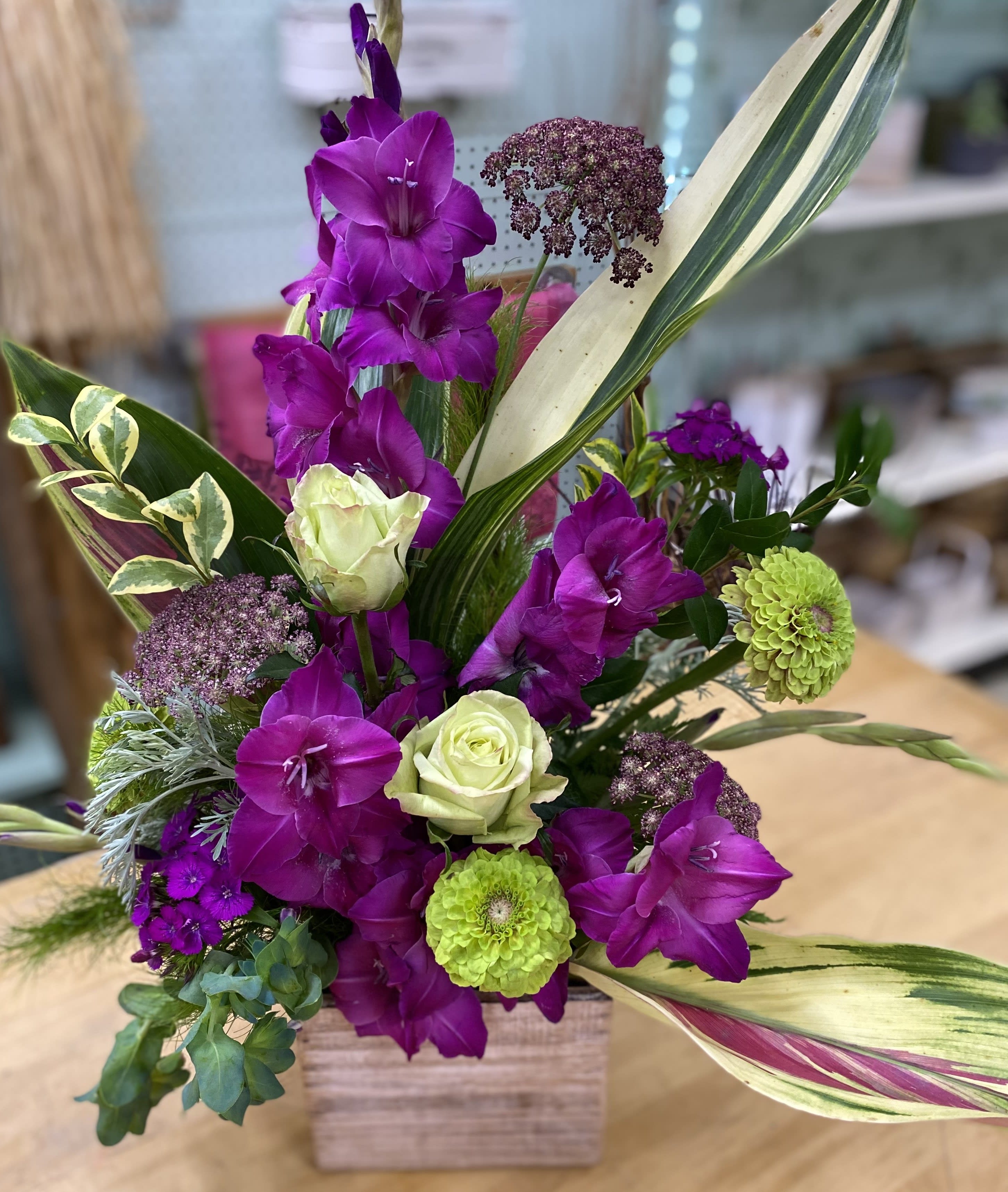 Pop of Purple  - Bold purple wooden box vase arrangement made up with gladiolus, roses, and dahlias. 