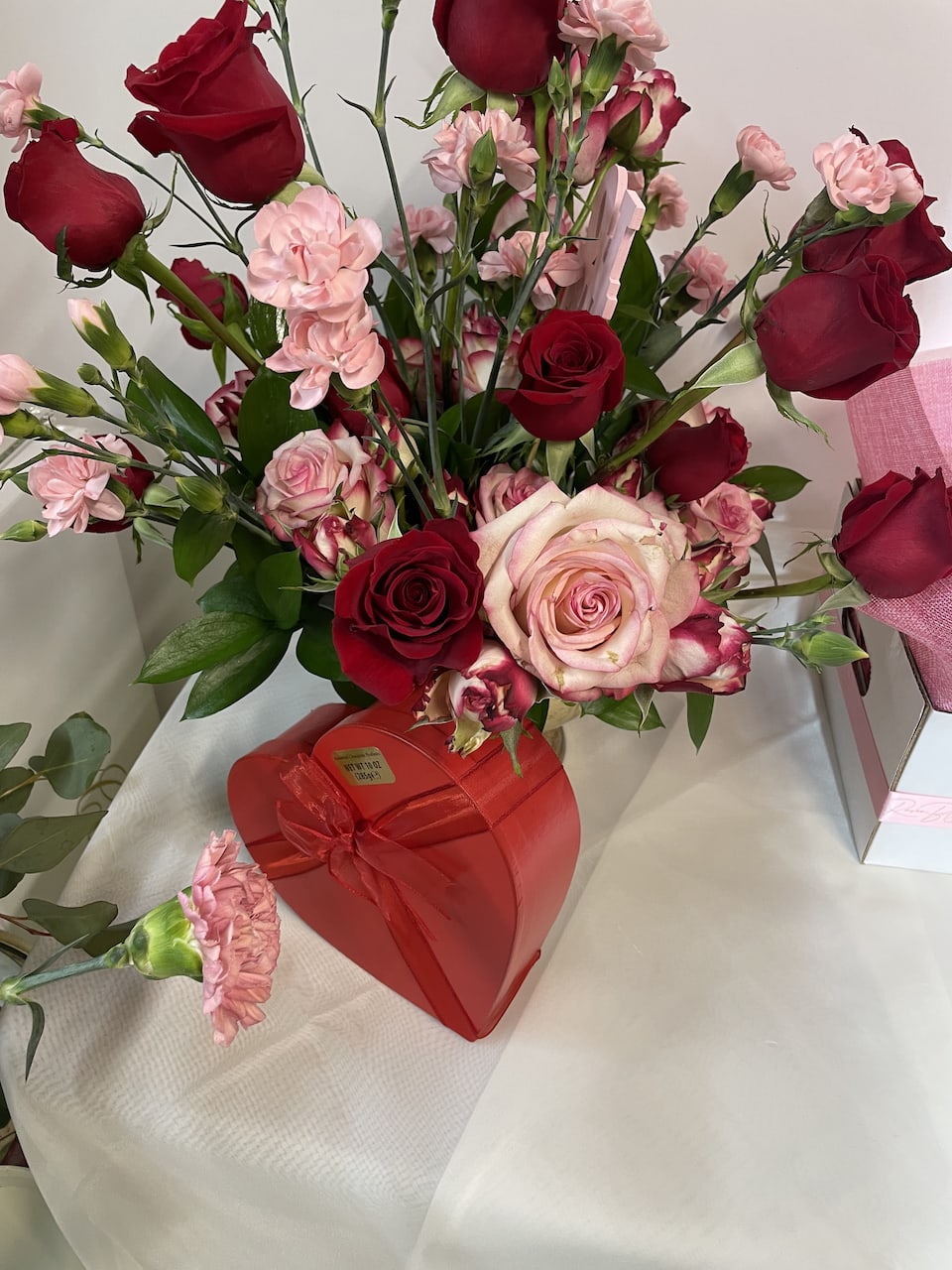  A Little Love In Your Heart - Pink and white roses, greenery and a box of heart chocolate 