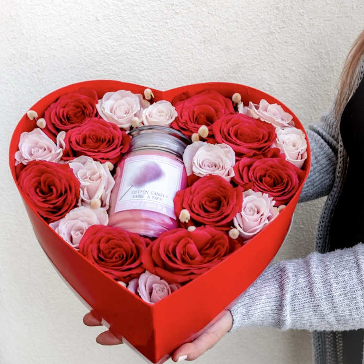 Lighted Blooms Box - A heart-shaped box brimming with the timeless romance of red and pink roses, accompanied by the sweet embrace of a scented candle! Elevate the moment with passion and fragrance by sending this bouquet all in one package.   