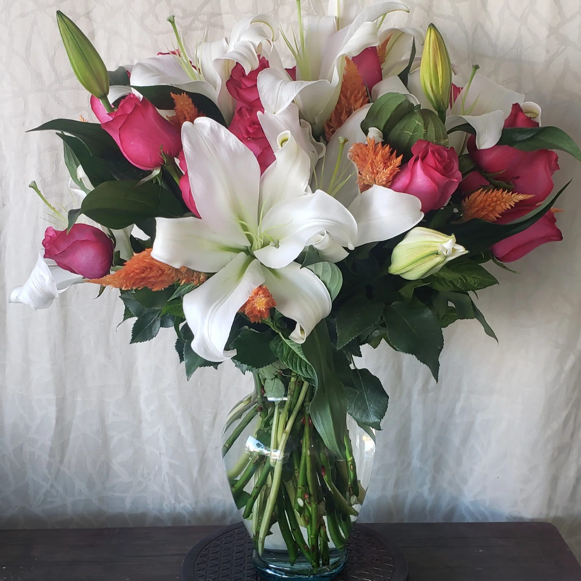 Lily and Rose - Beautiful fragrant Orientals and Fuchsia roses. (Picture shown is Deluxe)   Cylinder keepsake box sub out vase for easy transport