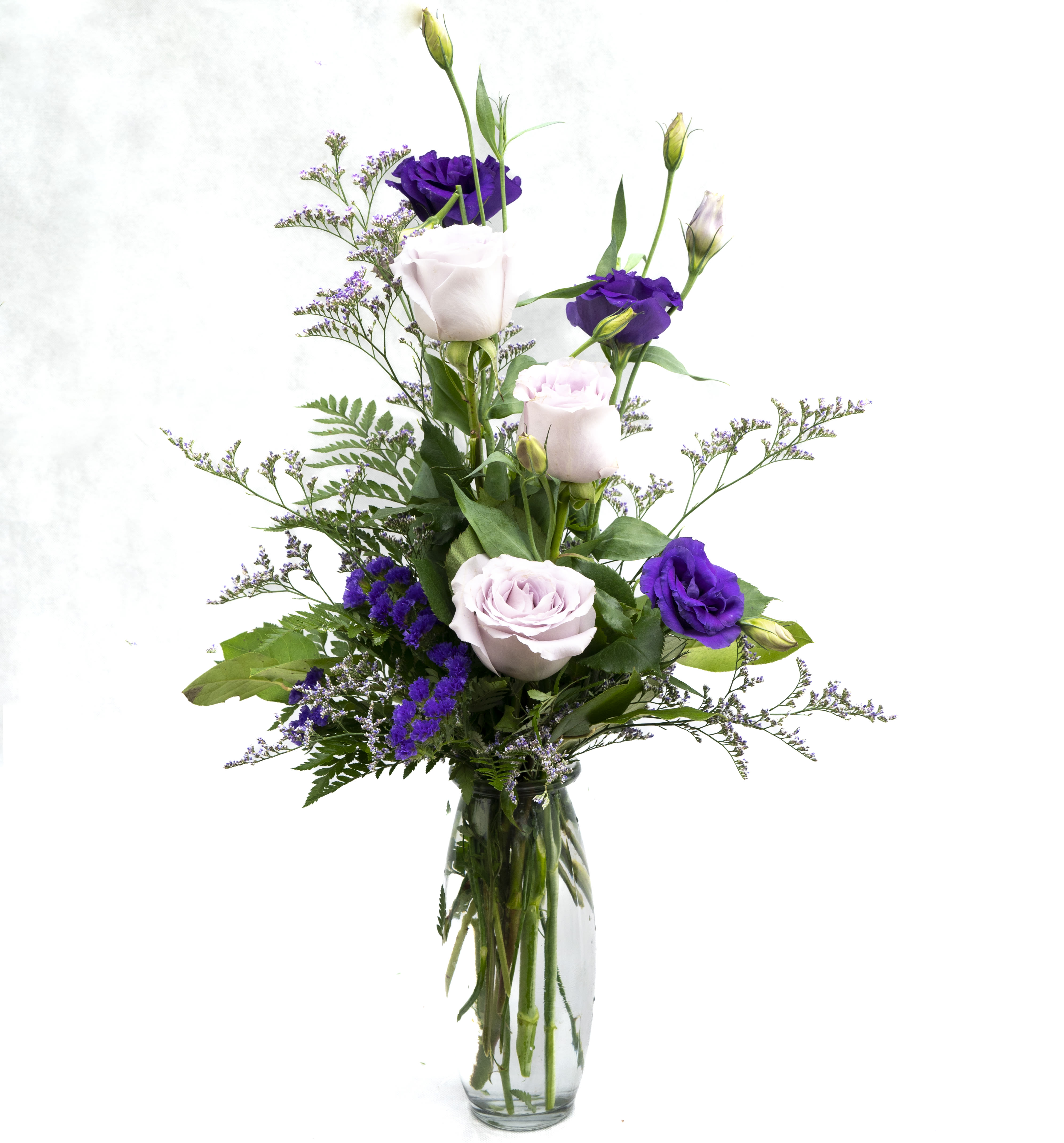 Sweet and Lavender - A budvase filled with beautiful blooms of lavender Roses, purple Lisianthus, lavender Limonium, and Statice. 