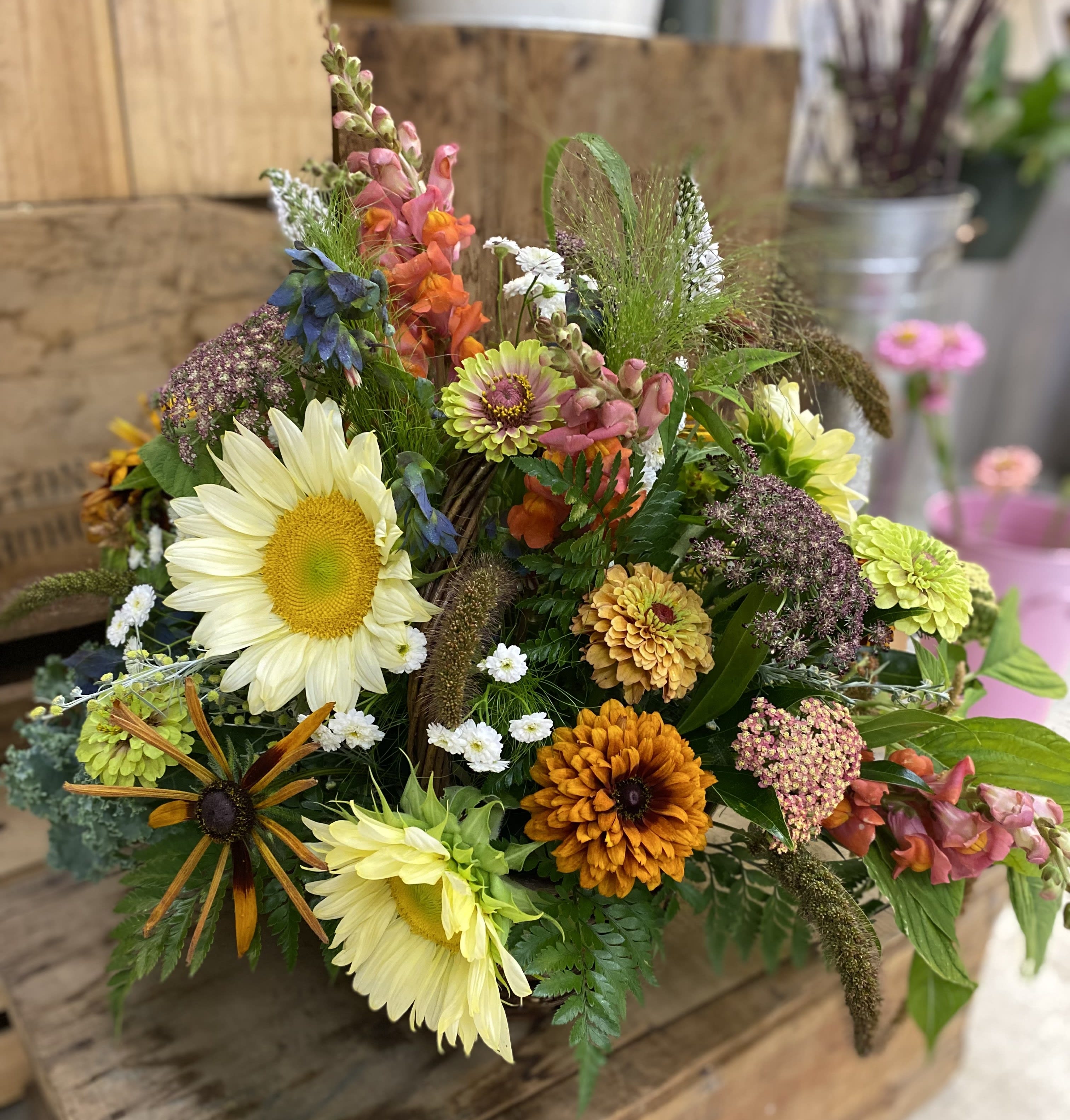 Rustic Basket - Sunflower, zinnias, snapdragons, and queen Ann's lace in a basket. 