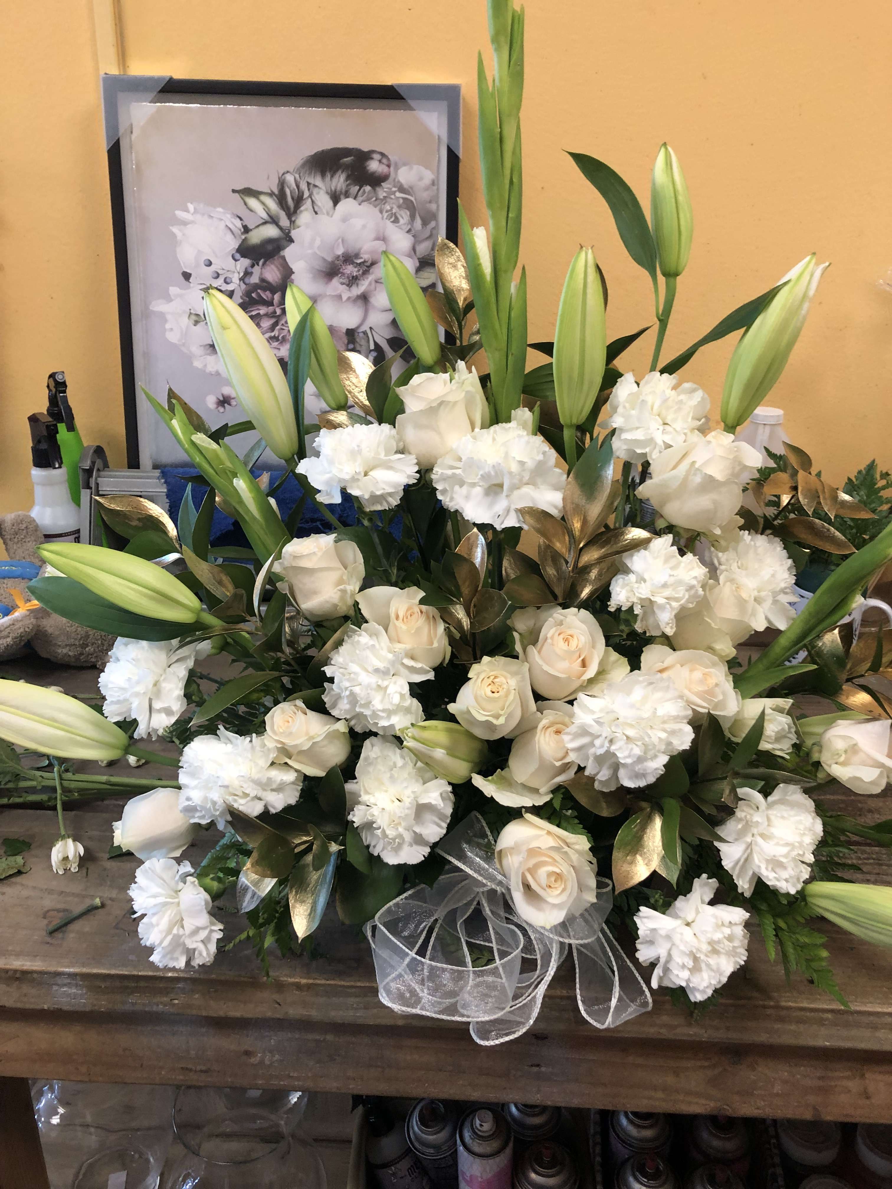 U WILL BE MISSED U WILL BE MISSED - AN ALL WHITE ARRANGEMENT INSIDE A WOOD BOX. FLOWERS TO INCLUDE LILIES, CARNATIONS AND 12 OFF WHITE ROSES WITH GOLD LEAVE FILLER. THIS IS ARRANGEMENT IS ABOUT 20 INCHES TALL AND 20 INCHES WIDE