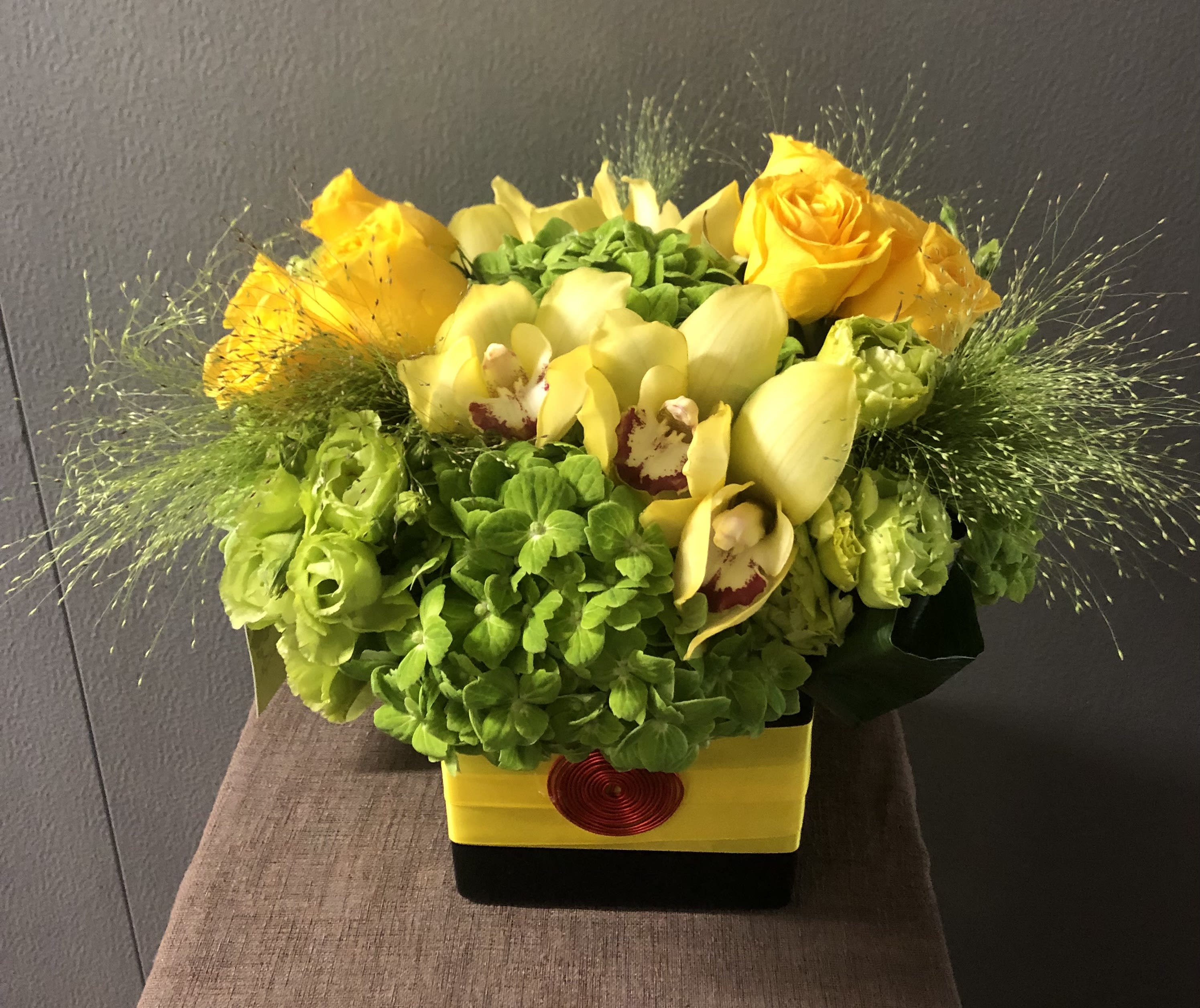 Splash of Happiness #EF105 - Happy Colors Arrangement of Green Hydrangea, Yellow Roses Yellow Orchids in an elegant black ceramic