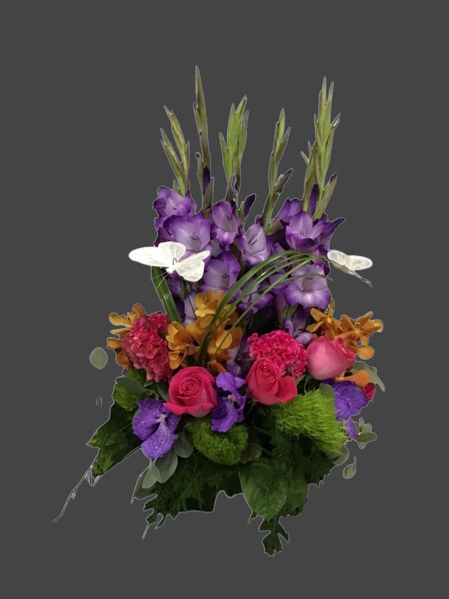 Nice and Lovely Nice and Lovely - nice and lovely low centerpiece with purple gladiolas, hot pink celosia, orange mokara orchids, hot pink roses, lavender vanda orchids, green dianthus, butterfly picks, custom designed in a clear 8 inch square cube vase.