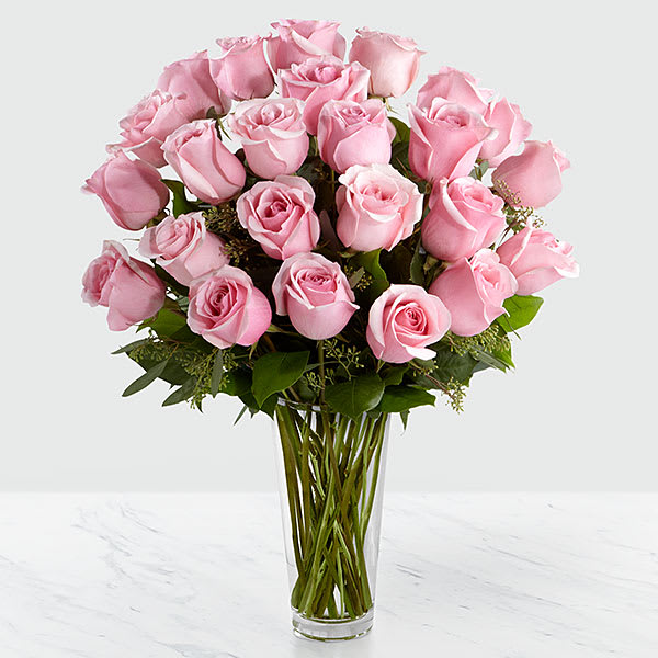 The FTD Pink Rose Bouquet (2 doz roses) - Picture-perfect soft pink roses make a beautiful gift for the lovely lady in your life. (Other colors are available) Wife, mother, daughter, or sweetheart she's sure to  cherish this bouquet of pastel  pink roses accented with different greens and arranged in a clear  glass vase.  Two dozen pink  roses!