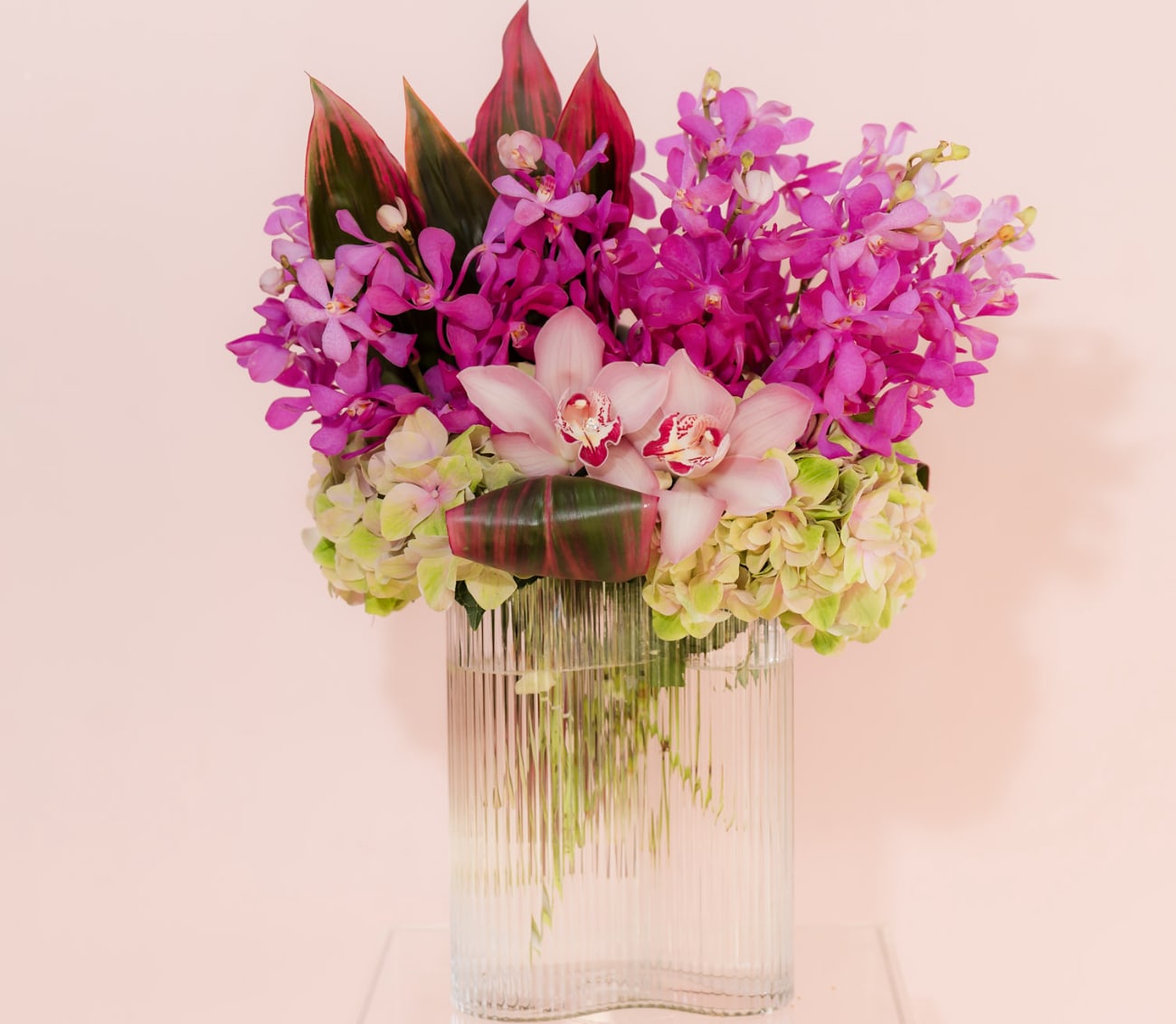 Valentines Day 3 - Tropical and Lovely - For that lovely person who seeks the unique, this tropical paradise design boasts assorted orchids and luxe foliage. 
