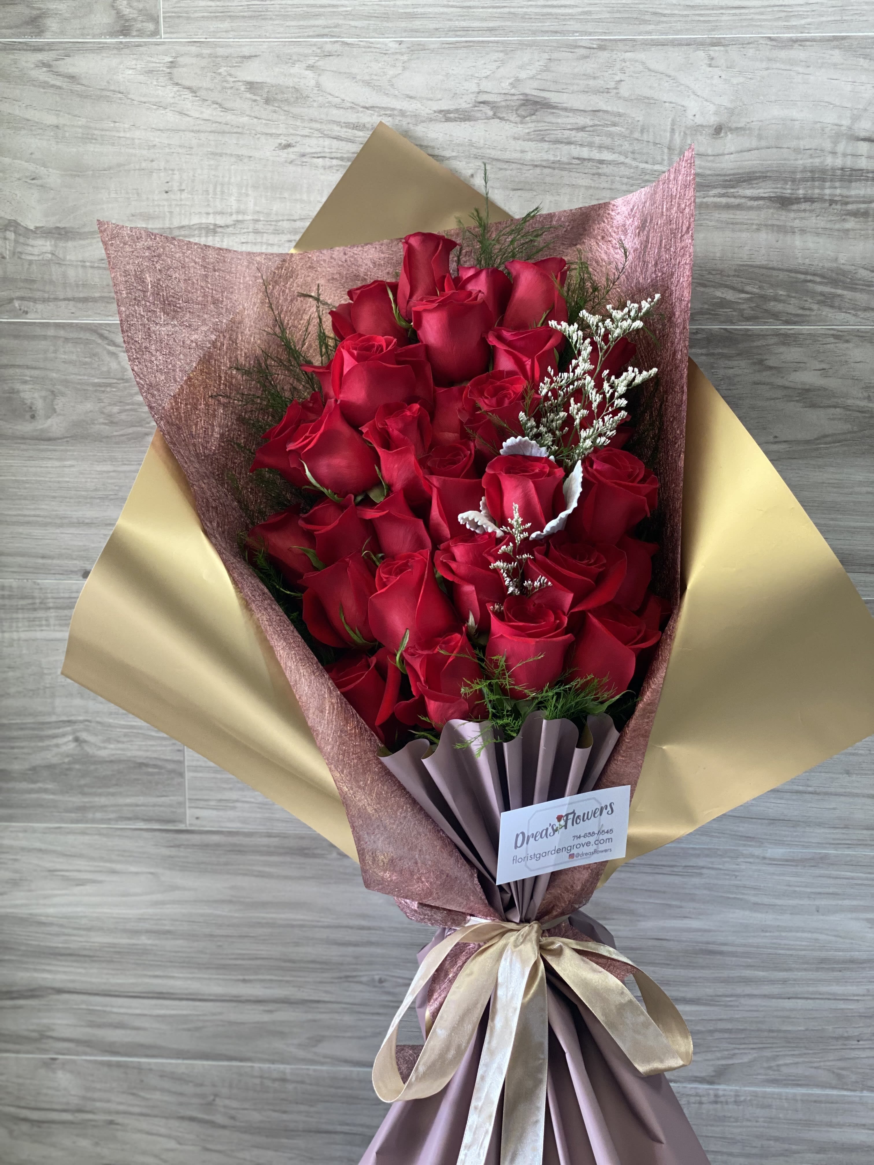 Pretty Lady - 30 red long stem roses wrapped in our rose gold boutique wrap. 
