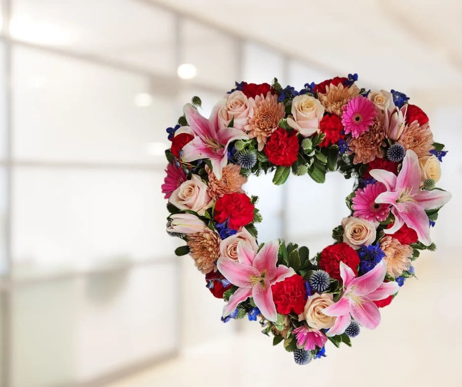 Light of my life heart wreath Light of my life heart wreath - Heart shaped memorial wreath, designed with assorted femanine colors including pink, peach, purple and a touch of dark blue.