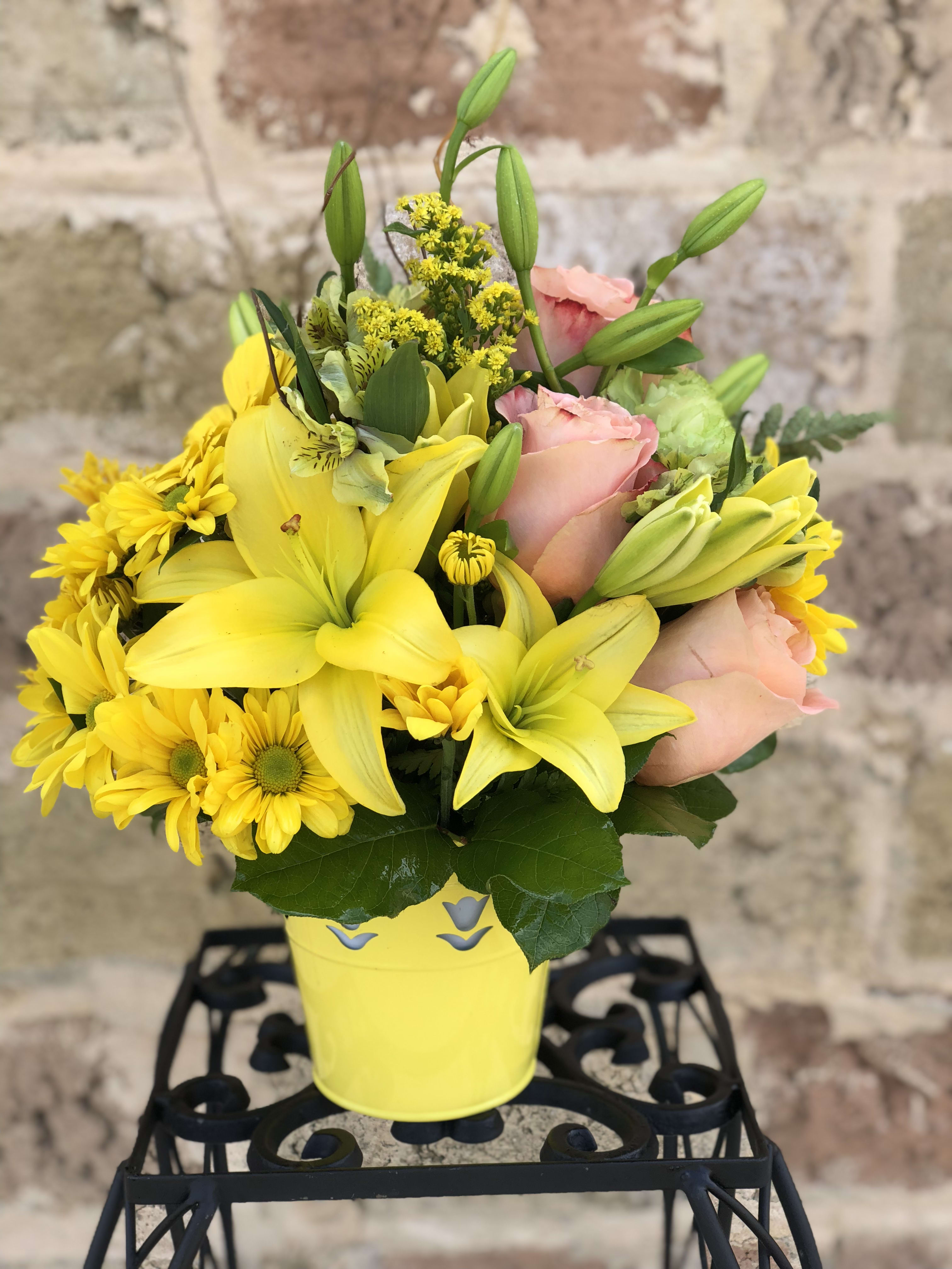 Sunshine Splendor - Bright-yellow lilies and fire-orange roses awaken the senses with sunny greetings for any occasion. Brighten someone's day today!  Approximate Measurements: 11 H x 9 W .
