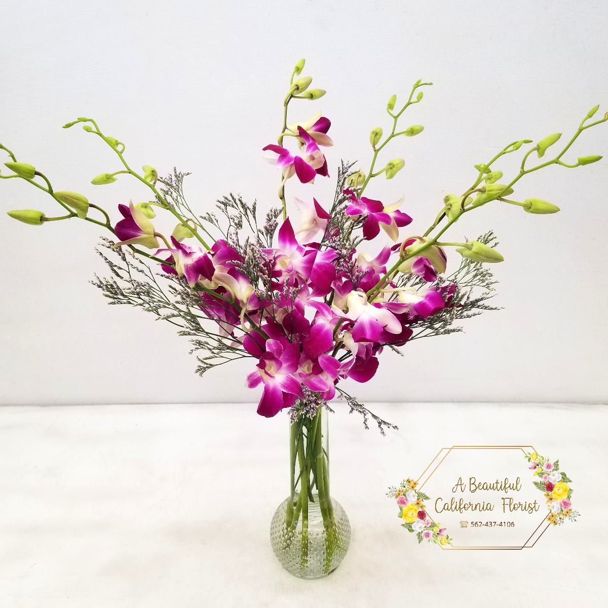 Orchid Symphony - Beautiful dendrobium orchids spill out in a symphony of lavender hues. Accented flowers are the finishing touch. Orchid Symphony from Long Beach favorite flower shop, A Beautiful California Florist, we deliver. Order today!