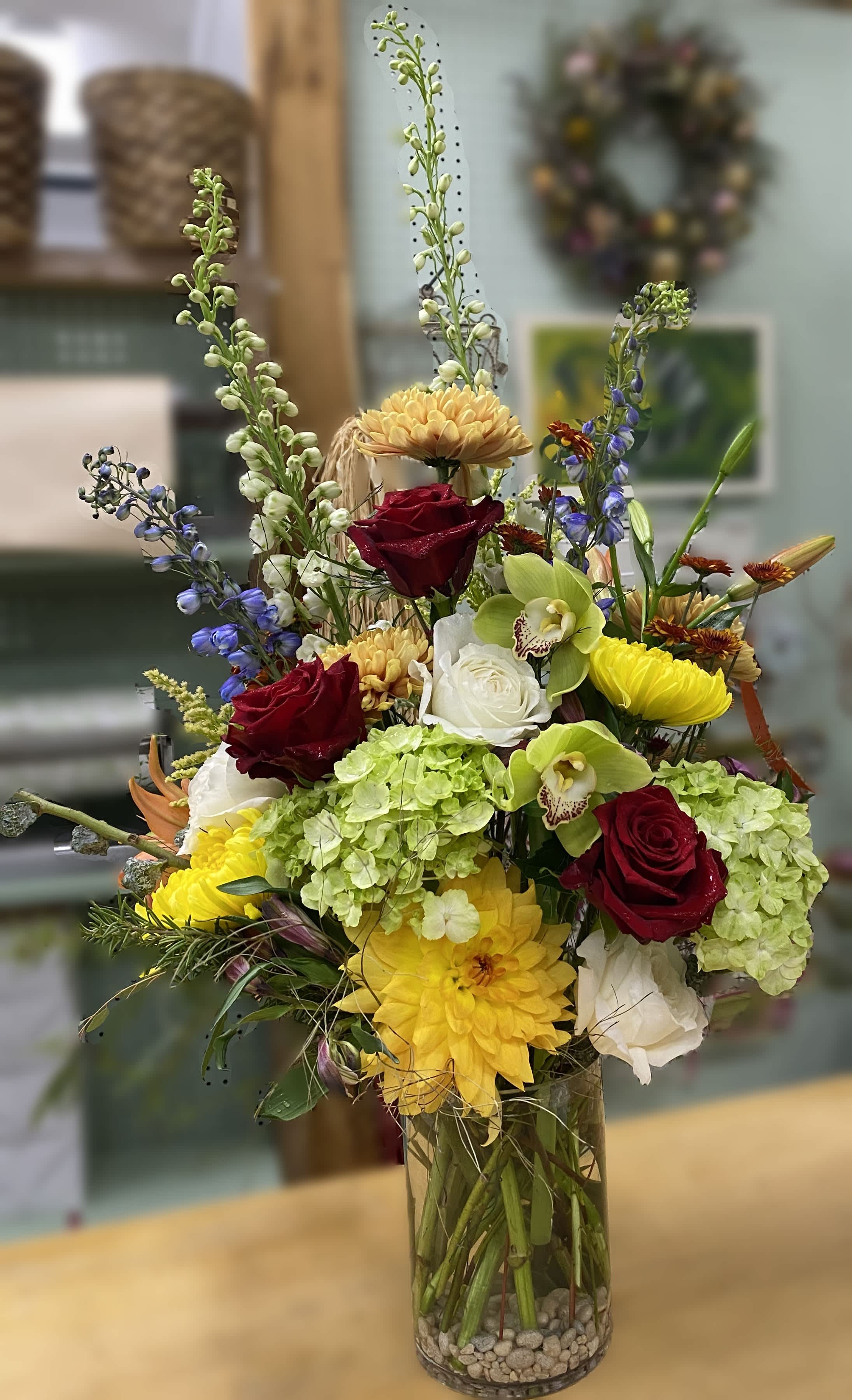 Mixed Emotions - Tall vase arrangement with pops for color. Roses, hydrangea, delphinium, and orchids. 