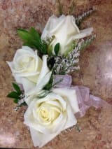 Corsage with White Roses - Wristlet or pin on style featuring gorgeous white roses accented with filler and greens and a ribbon to match the wearer's outfit. 