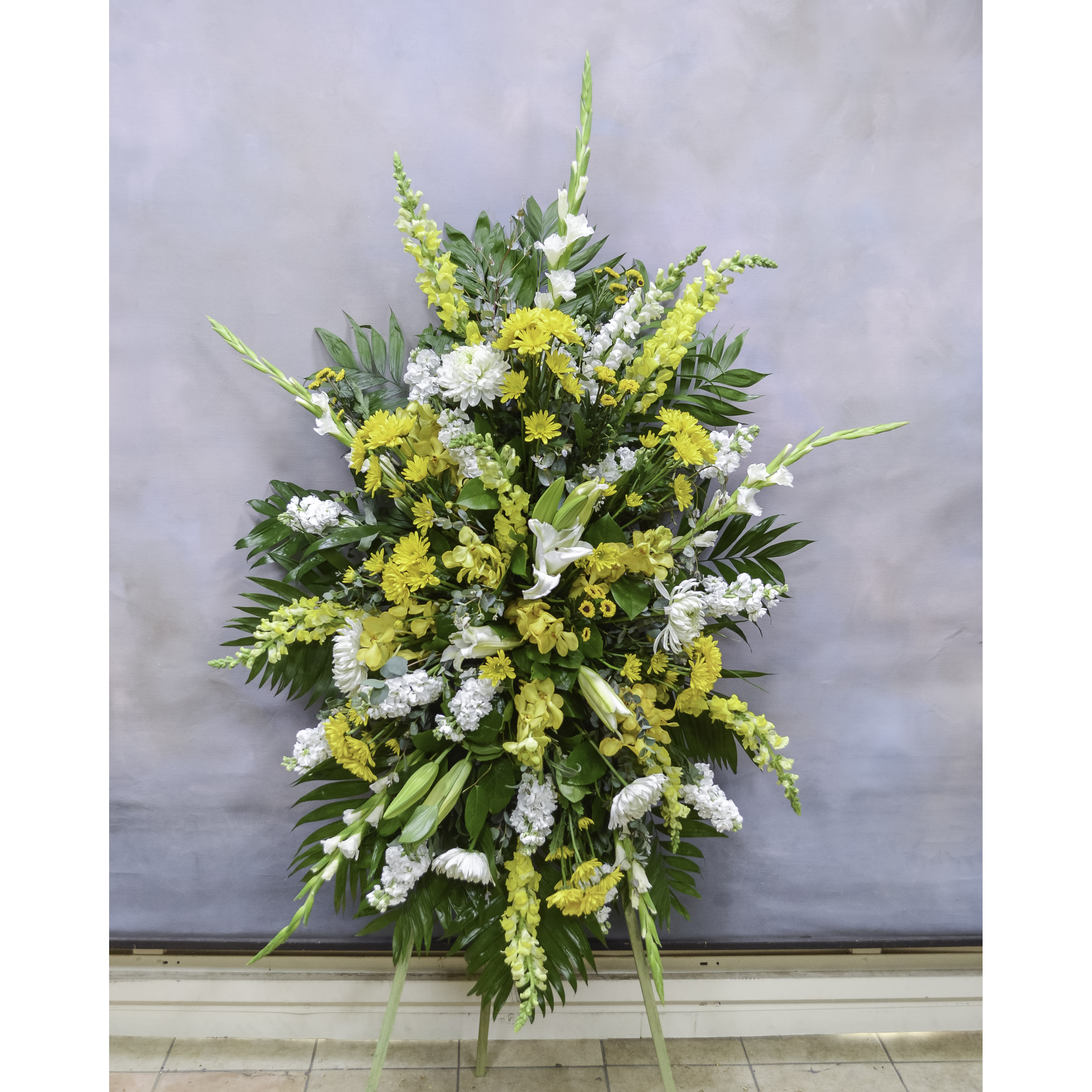 Summer Dreams - Standing Spray (SF715) - This sympathy standing spray, in the colors yellow, white, and green, is a stunning symbol of your sympathy and support.