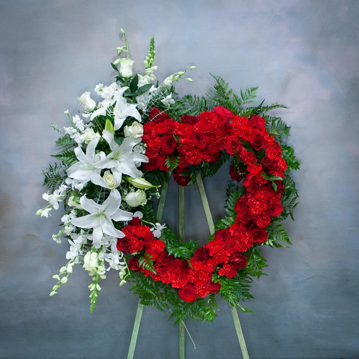 Cherished Moments - Standing Spray (SF719) - This heart-shaped sympathy standing spray, in the colors red and white, is a stunning symbol of your sympathy and support. *Measures 24 inches in diameter.