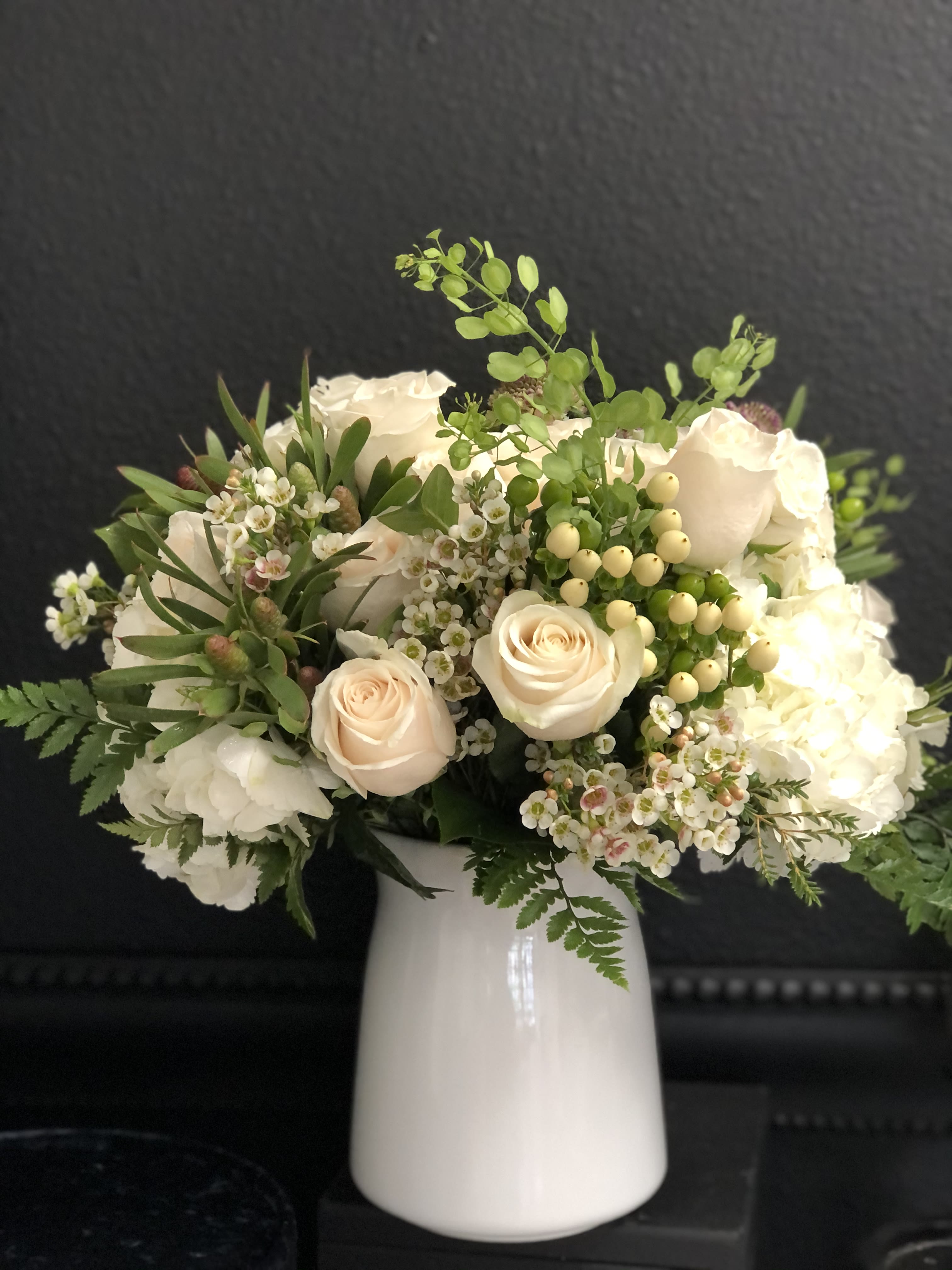 White Vase White Vase - Mix of whites and greens in ceramic white vase. Delightful arrangement for any occasion.