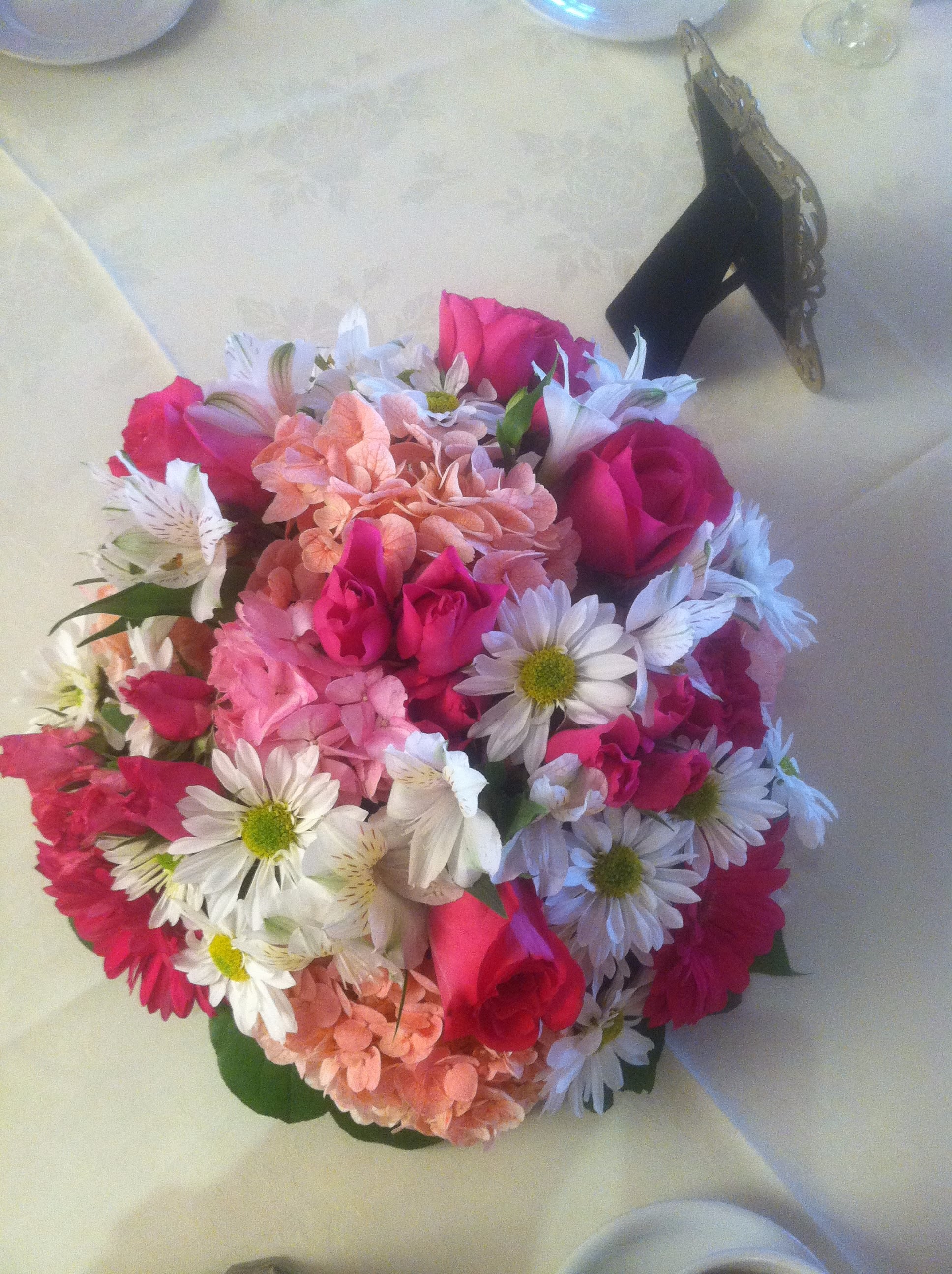 Beautiful Pink and White Centerpiece - A gorgeous centerpiece made with the most beautiful mix of flowers; makes for a much talked about piece at parties, home dinners, and even makes for a great gift! With both hot and light pink flowers, a touch of white and peach, and some added greenery...it's a perfect marriage of flowers to make a stunning masterpiece. Includes roses, baby roses, alstro, hydrangea, daisies, and greenery. 