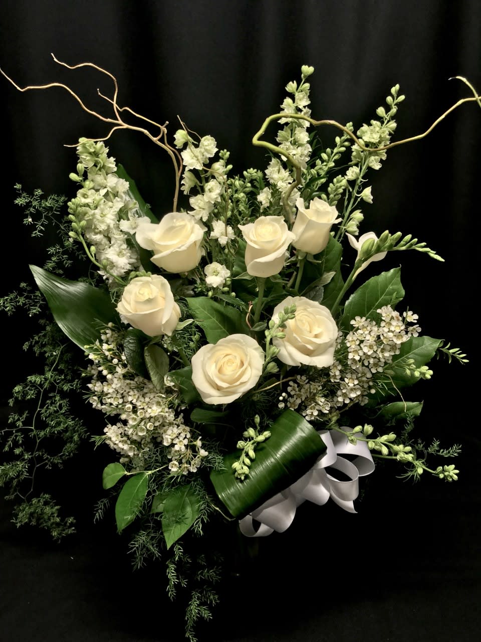 Pure white bouquet with roses and willow - Striking and elegant all white bouquet is appropriate for sympathy and renewal.  Order at least one week ahead if possible or we may need to make substitutions and /or add a color!  Assortment of accent flowers will vary.