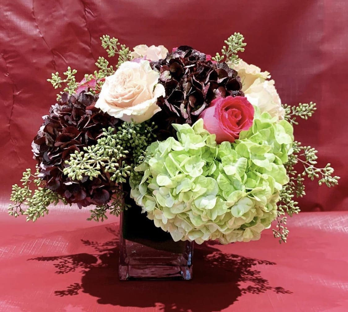 Custom Arrangement of Roses &amp; Hydrangea in clear glass cube with leaf wrap - Custom Arrangement of Roses &amp; Hydrangea in clear glass cube with leaf wrap.