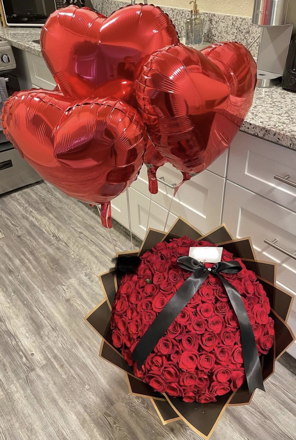 Red Roses express just how much she means to you - 100 Red Roses , balloons and ribbon makes this Ramo Buchon one of a kind 