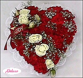 Casket Heart in Red Casket Heart in Red - This casket heart is made up of fresh red carnations with a sheath of white roses, outlined in white lace and accented with a matching ribbon.