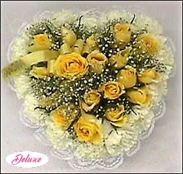 Rose Casket Heart Rose Casket Heart - Vibrant roses are surrounded by a collection of fresh carnations and white lace. Baby's breath, fresh greenery, and a matching ribbon accent this casket heart. Other colors available, please mention your color preferences when ordering.