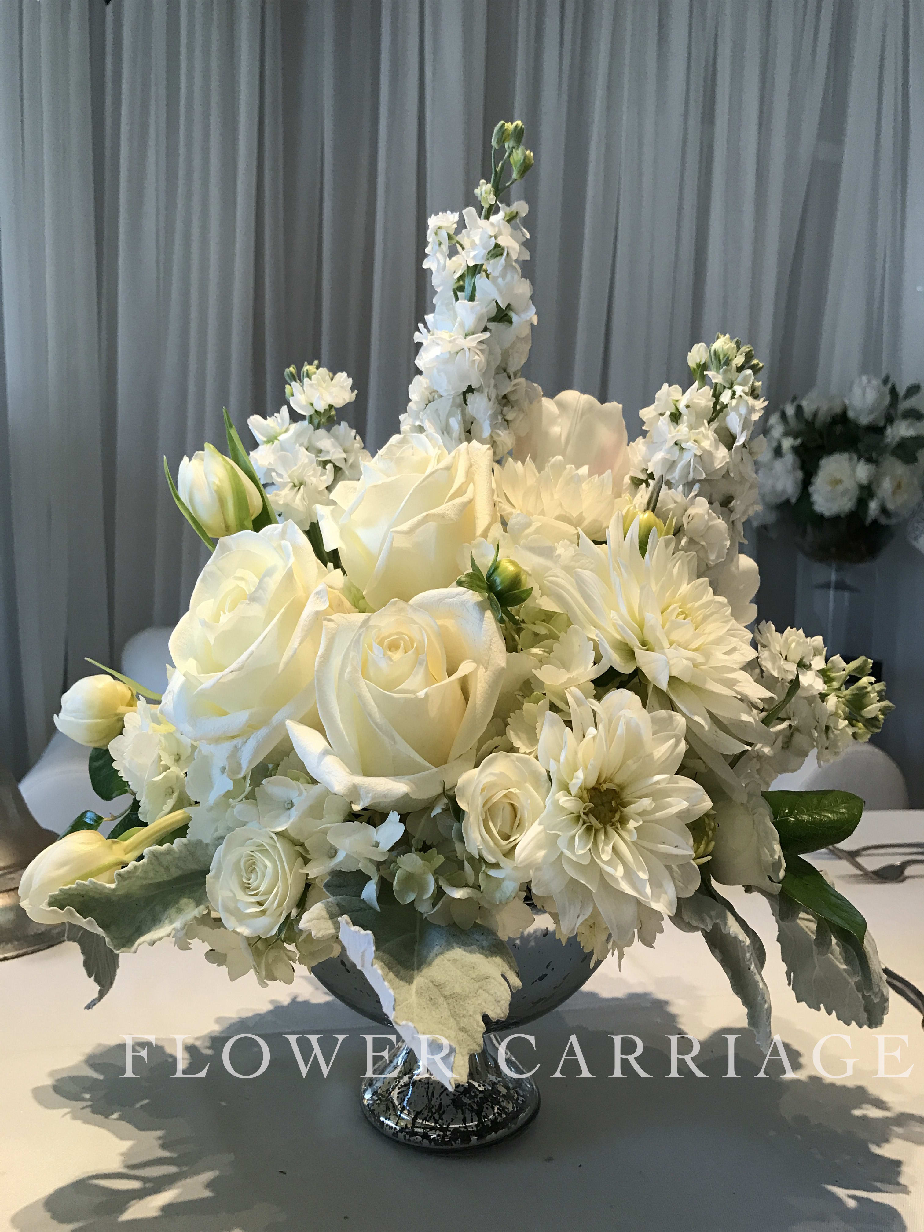 Pristine Whites Bouquet  - These flowers capture the essence of purity and innocence. They make an elegant centerpiece or a heartfelt sympathy arrangement.  This arrangement includes; Roses, Dahlia, Spray Roses, Tulips, Stock and more.