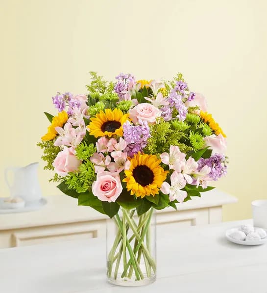 Garden of Grandeur - Our best-selling spring bouquet is inspired by the traditional, hand-tied arrangements found in flower markets throughout Europe. Gathered with a mix of vibrant blooms inside a classic glass vase, it brings a cheerful taste of old-world charm to the people you care about. VASE WILL VARY
