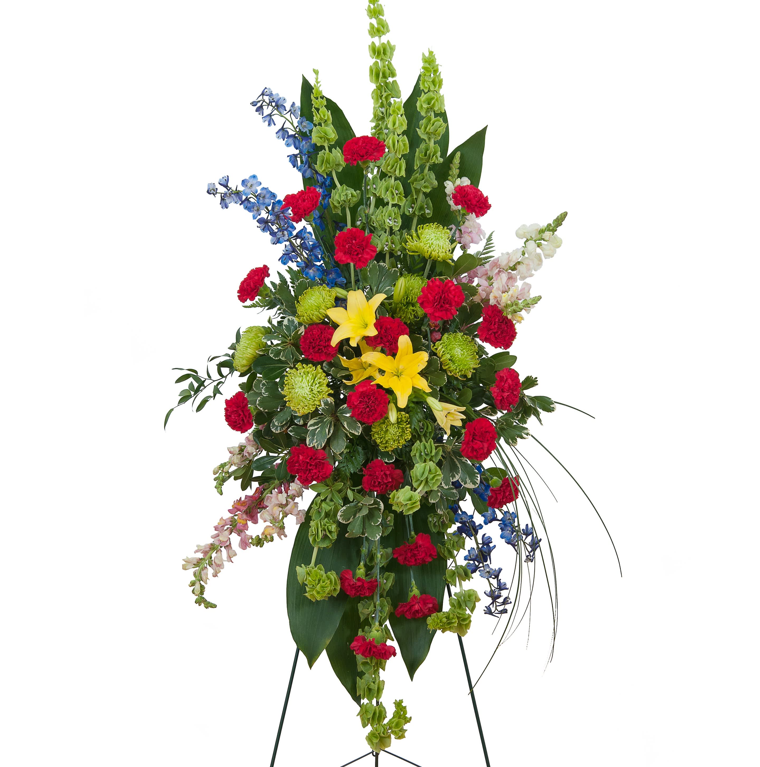 Treasured Celebration Standing Spray - A combination of bright color blooms to celebrate the life of your loved one.