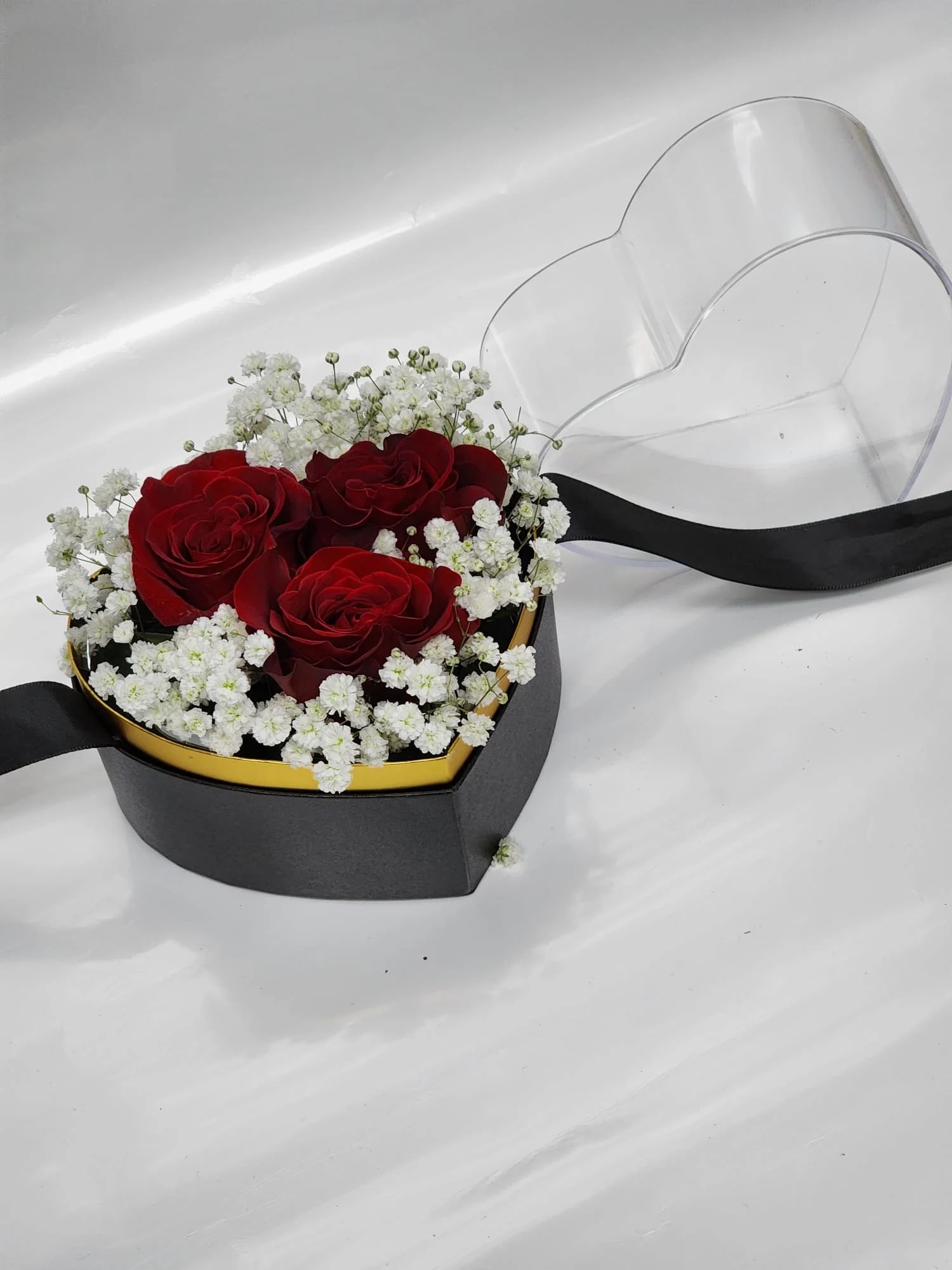 My little Heart - 3 red roses, white baby breath  in a small   shape heart  container  