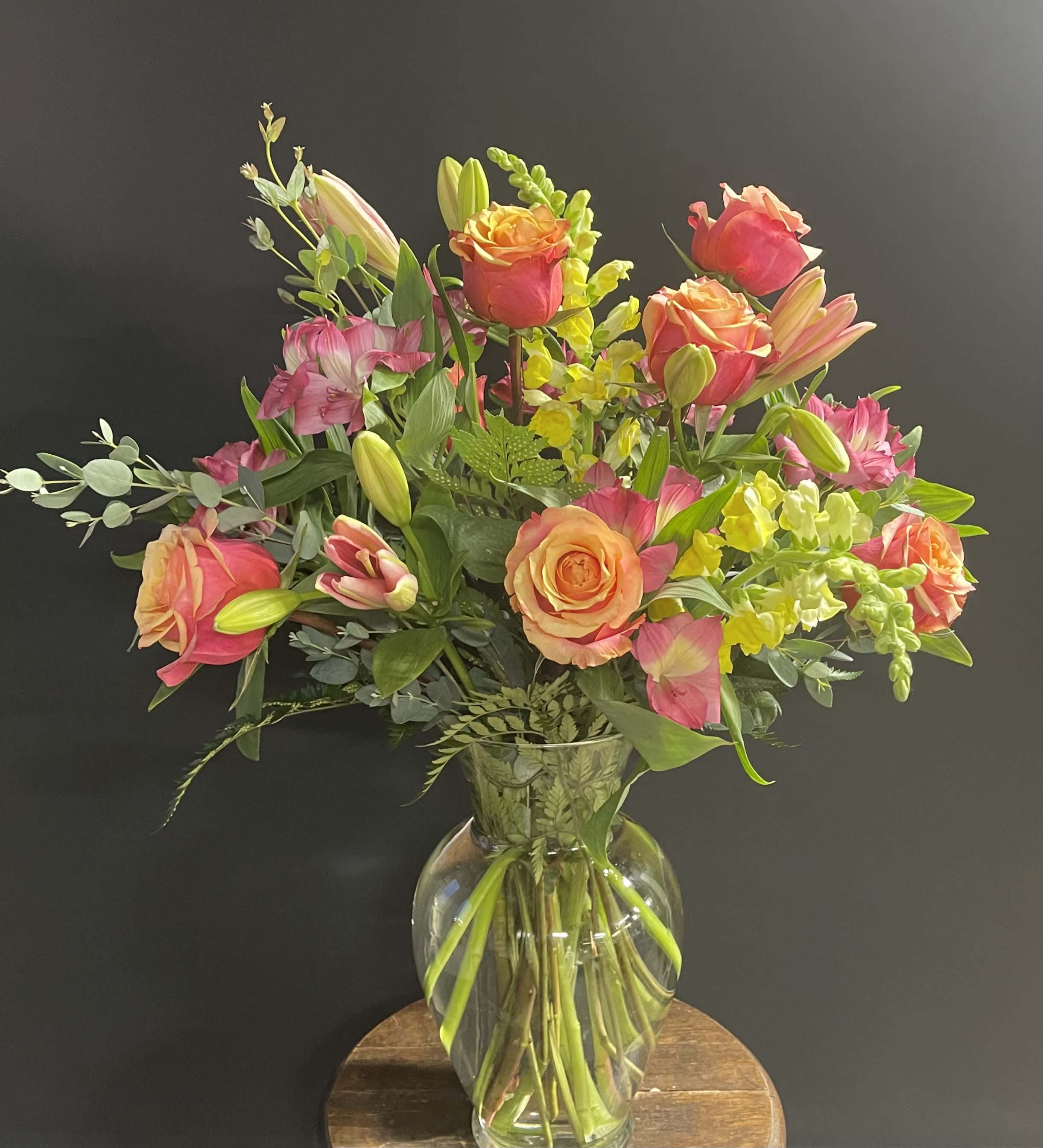 Orange Sherbet Bouquet - Beautiful bi-color roses in orange to dark pink paired with yellow snapdragons, pink asiatic lilies, and pink alstromeria.