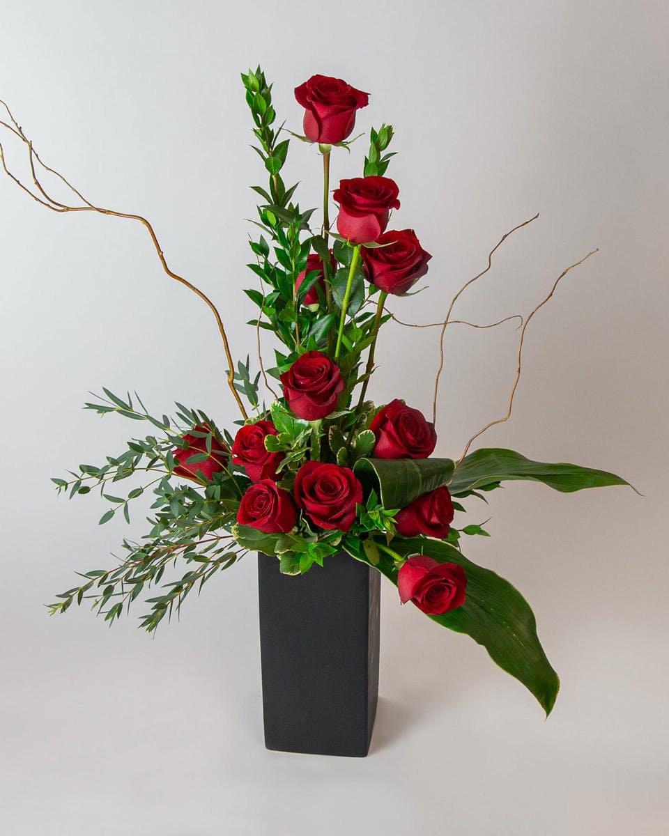 Roses with Style - This contemporary arrangement of 1 dozen roses is sure to WOW.  Other colors are available upon request.  Vase color may vary depending on availability