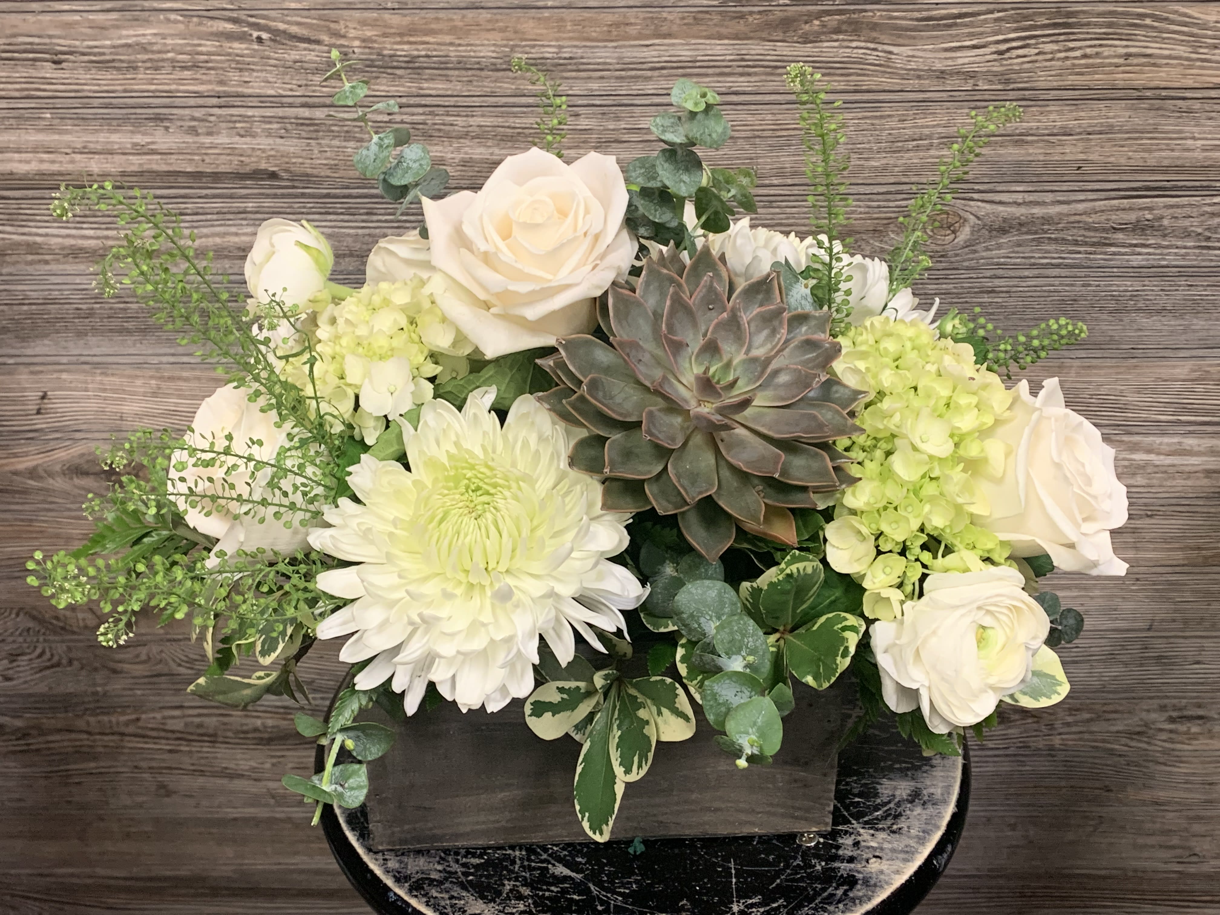White Rustic Box  - Wooden 7x5 rustic wooden box accented with a succulent. white cremons, green hydrangeas, green dragon, ranunculus, roses and seasonal greenery. 