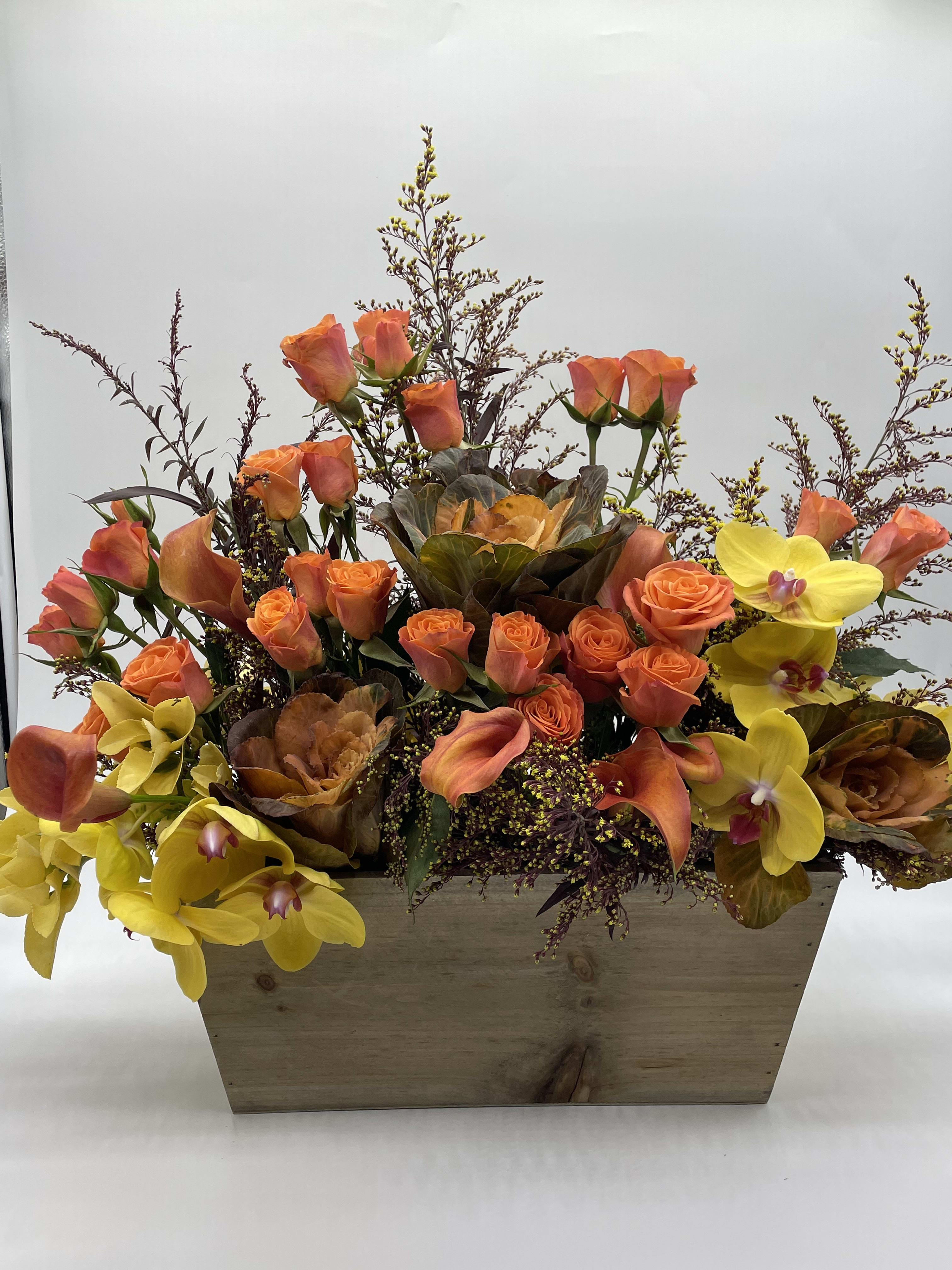 Apricot - A Beautiful combination of orange roses mixed with calla lilies and bright yellow orchids, great for the Thanksgiving celebration.