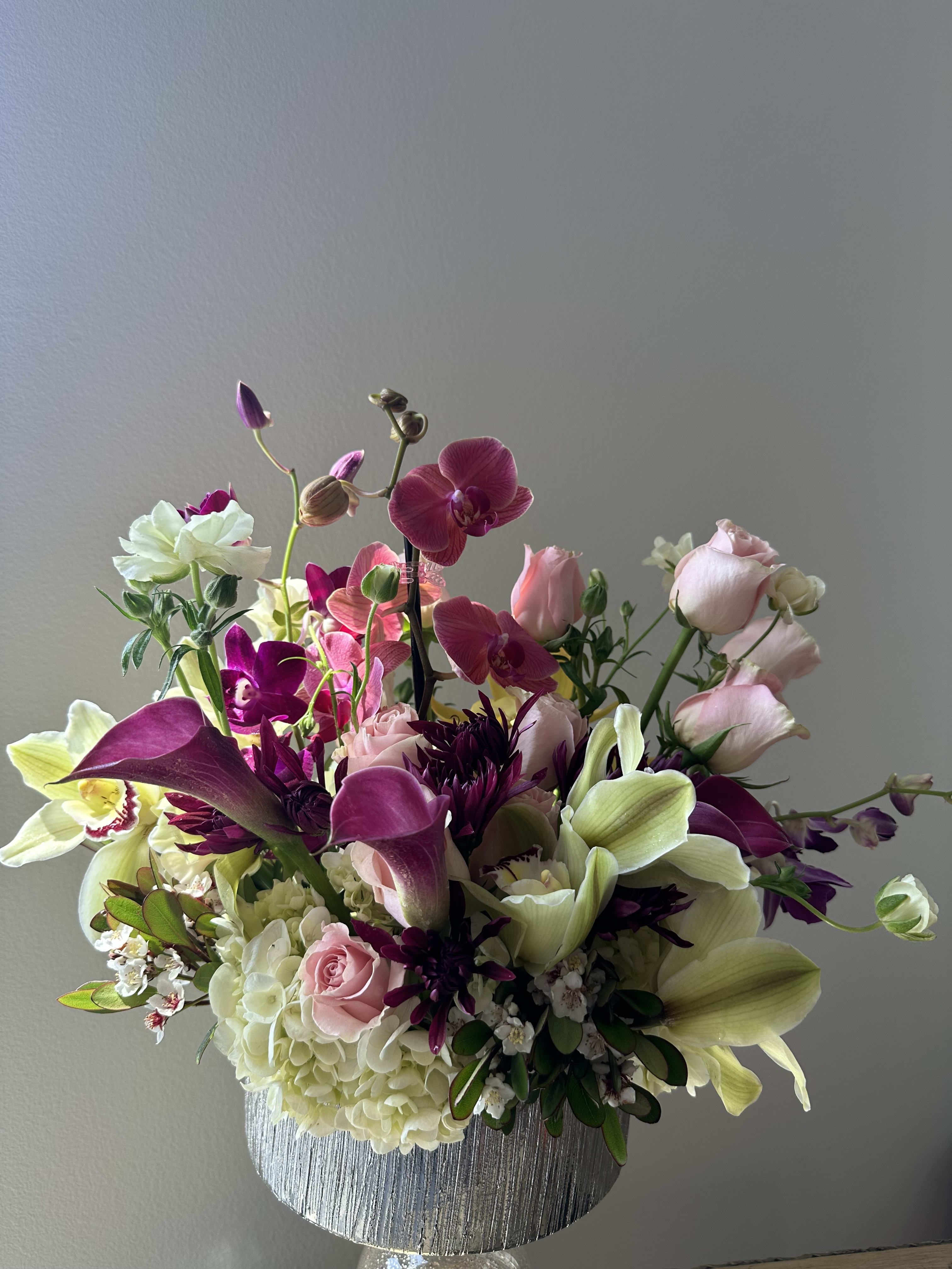 sweet melodies - A collection of phalaenopsis orchids, Cymbidium orchid, dendrobium orchids, pink roses on the bed of white hydrangeas