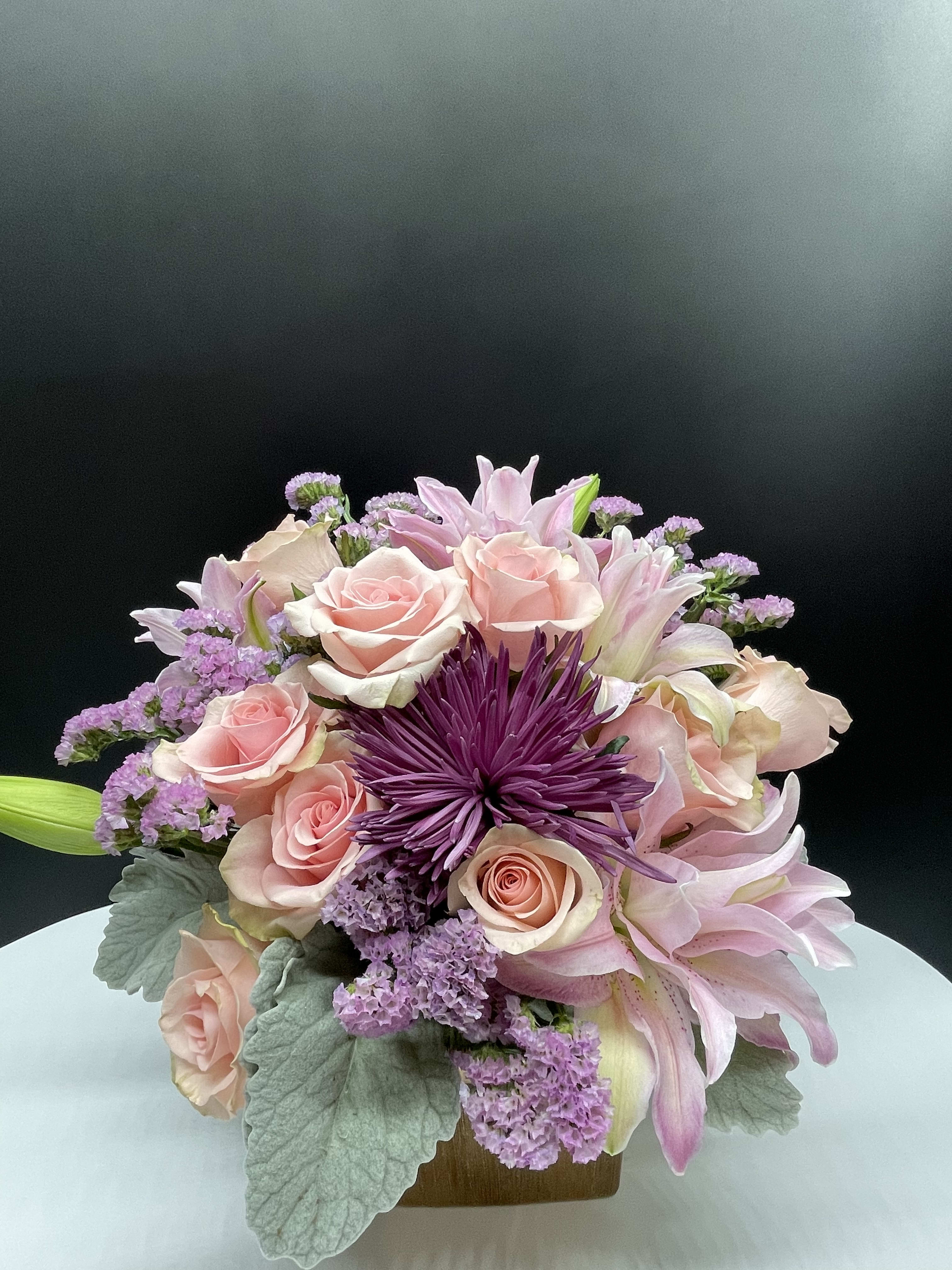 Fuchsia - A combination of pink roses,moms, rose lilies &amp; dusty miller in rose gold ceramic container. 