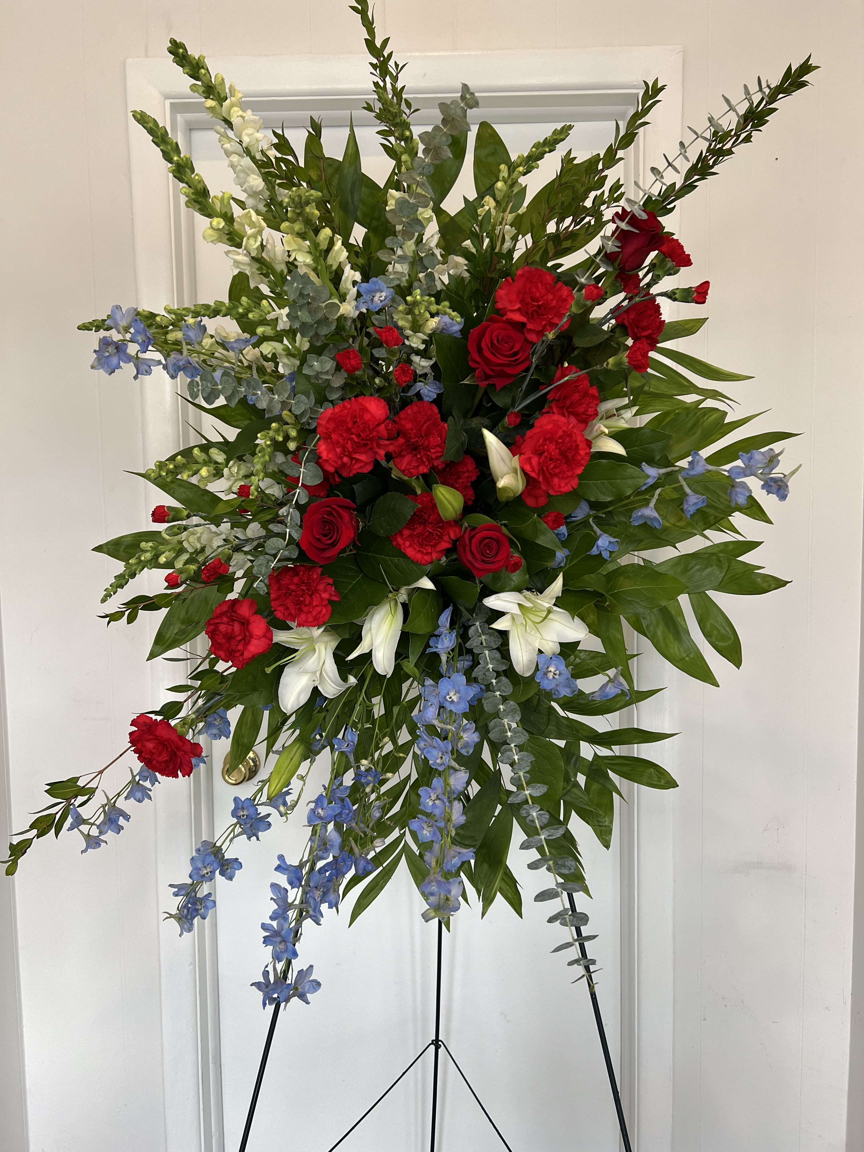 Patriotic Spray  - Standing spray of red roses, red carnations, white Lilly, blue delphinium and premium greens 