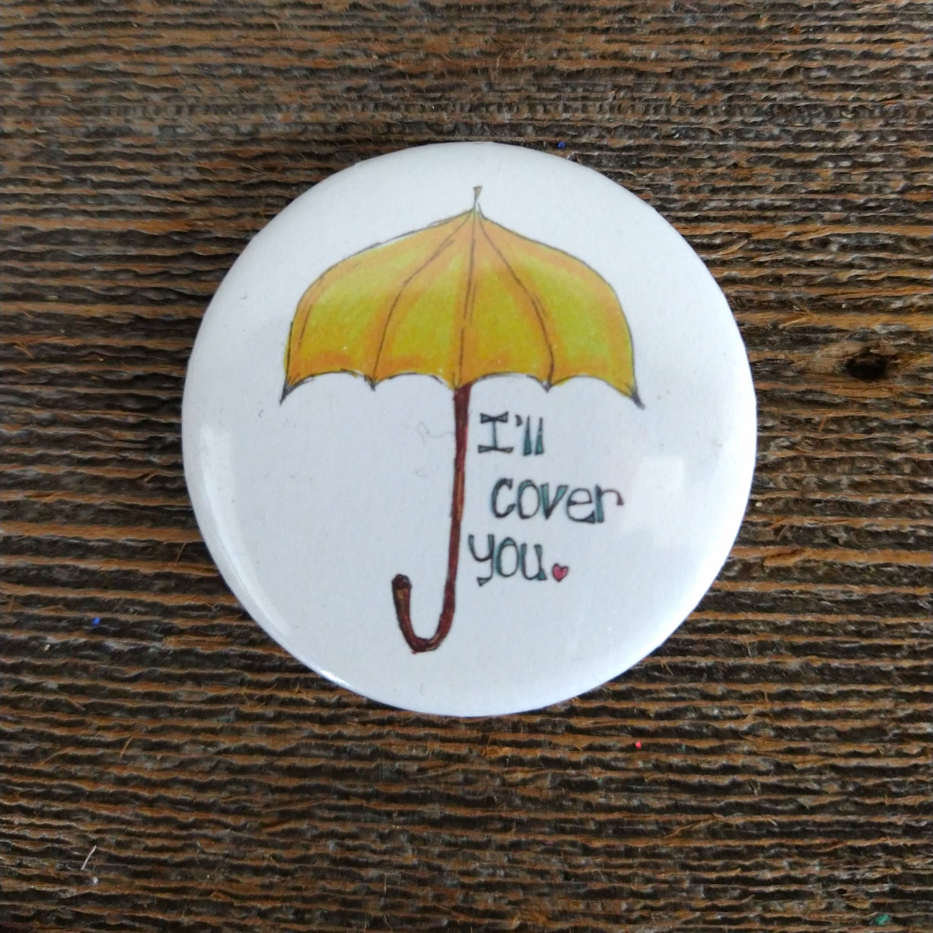 Cover You Umbrella Pin - Hand-made buttons created by a Courtney Calkins, a Humboldt native. 