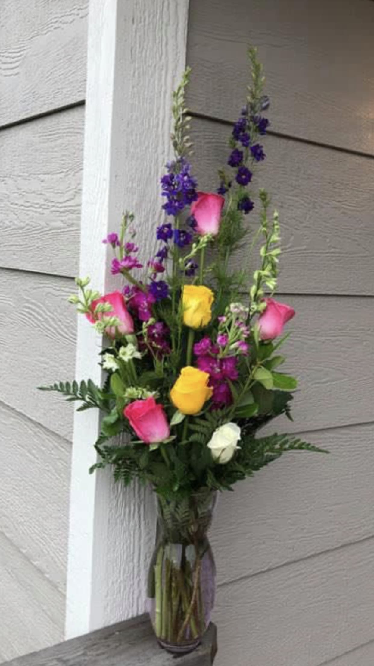 Assorted Roses - Tall arrangement with assorted roses and lark. 