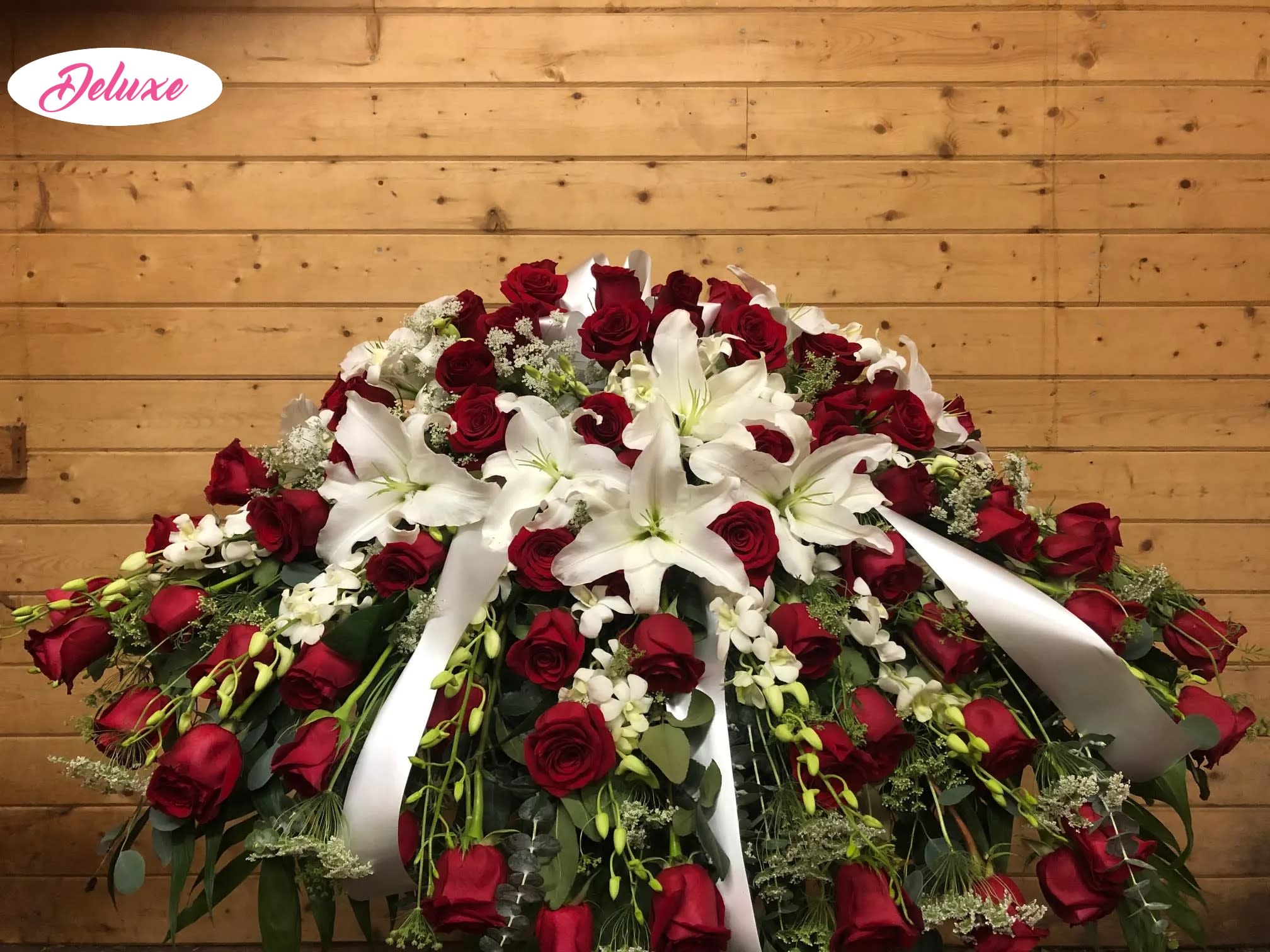 Red &amp; White Casket Cover  - This stunning casket cover of all red rose, white orchids and elegant white lilies is the perfect way to honor the memory of your loved one. Other color roses are available upon request. 
