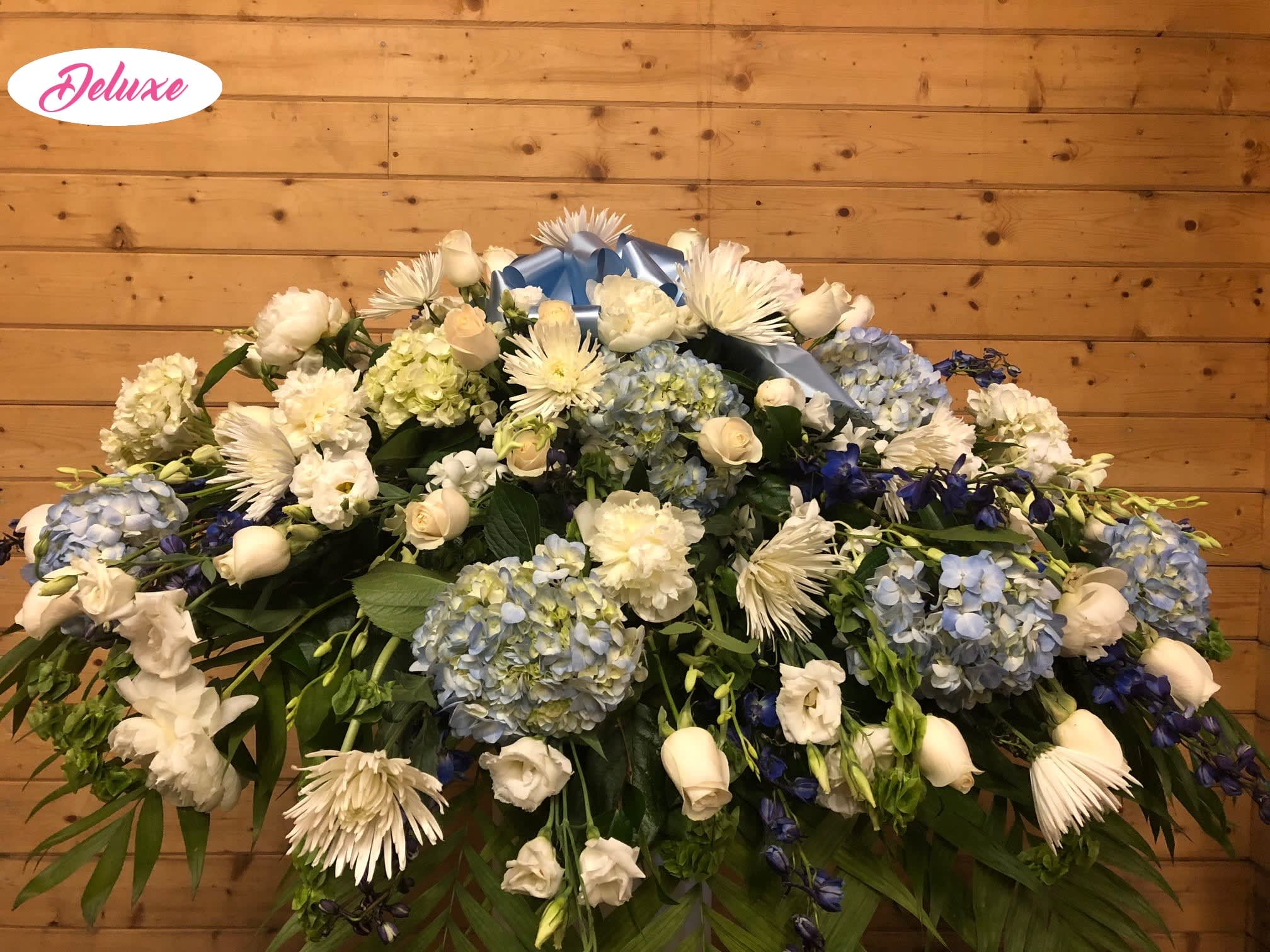 White & Blue Casket Spray White & Blue Casket Spray - A beautiful gathering of fresh flowers, all at their best in lovely shades of White & Blue. Flowers include Hydrangea, Roses, Spider Mums and other Beautiful Flowers