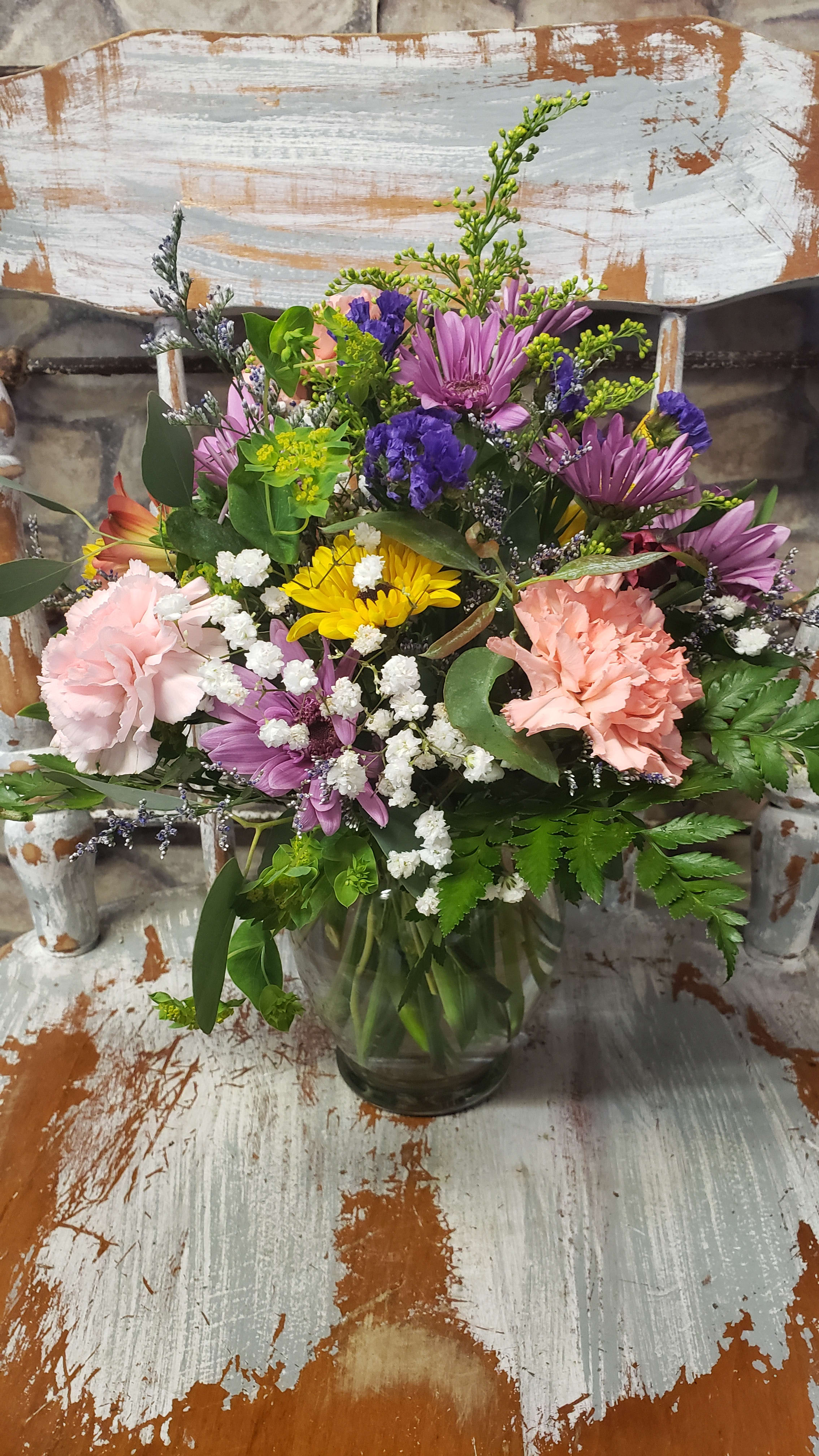 Petite Charmer - Sweet circular design of freshly mixed colors &amp; flowers based on market fresh inventory and availability at time of order/delivery. Flowers and colors can vary at times.