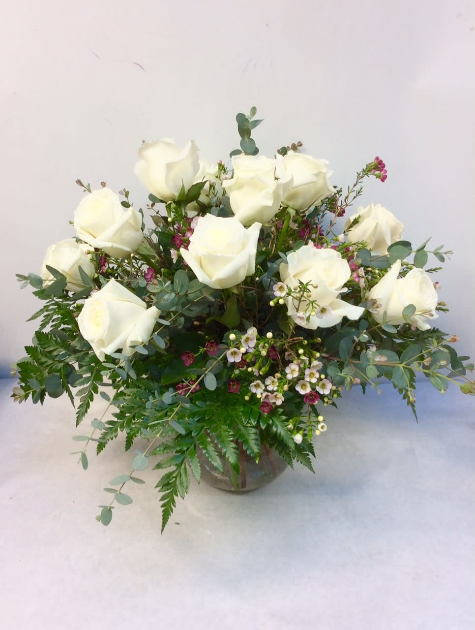 Victorian Romance by Hudson Flower Shop - A dozen cream roses, lavender waxflower and ivy are perfectly arranged in a clear glass vase. 
