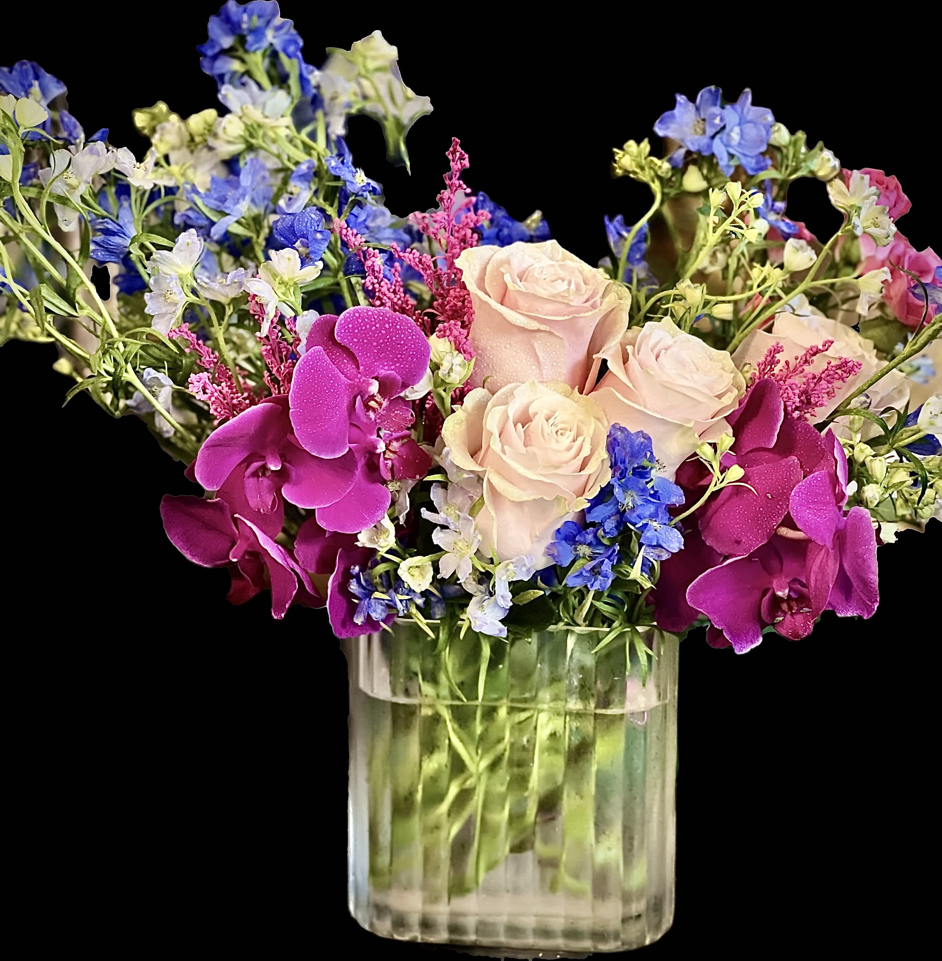 Enchanting Orchid Radiance - Introducing our Vibrant floral masterpiece, a captivating blend of orchids and roses harmoniously arranged with whimsical greens. Artfully arranged in a crystal-clear vase, this creation brings elegance and burst of color to any space.  
