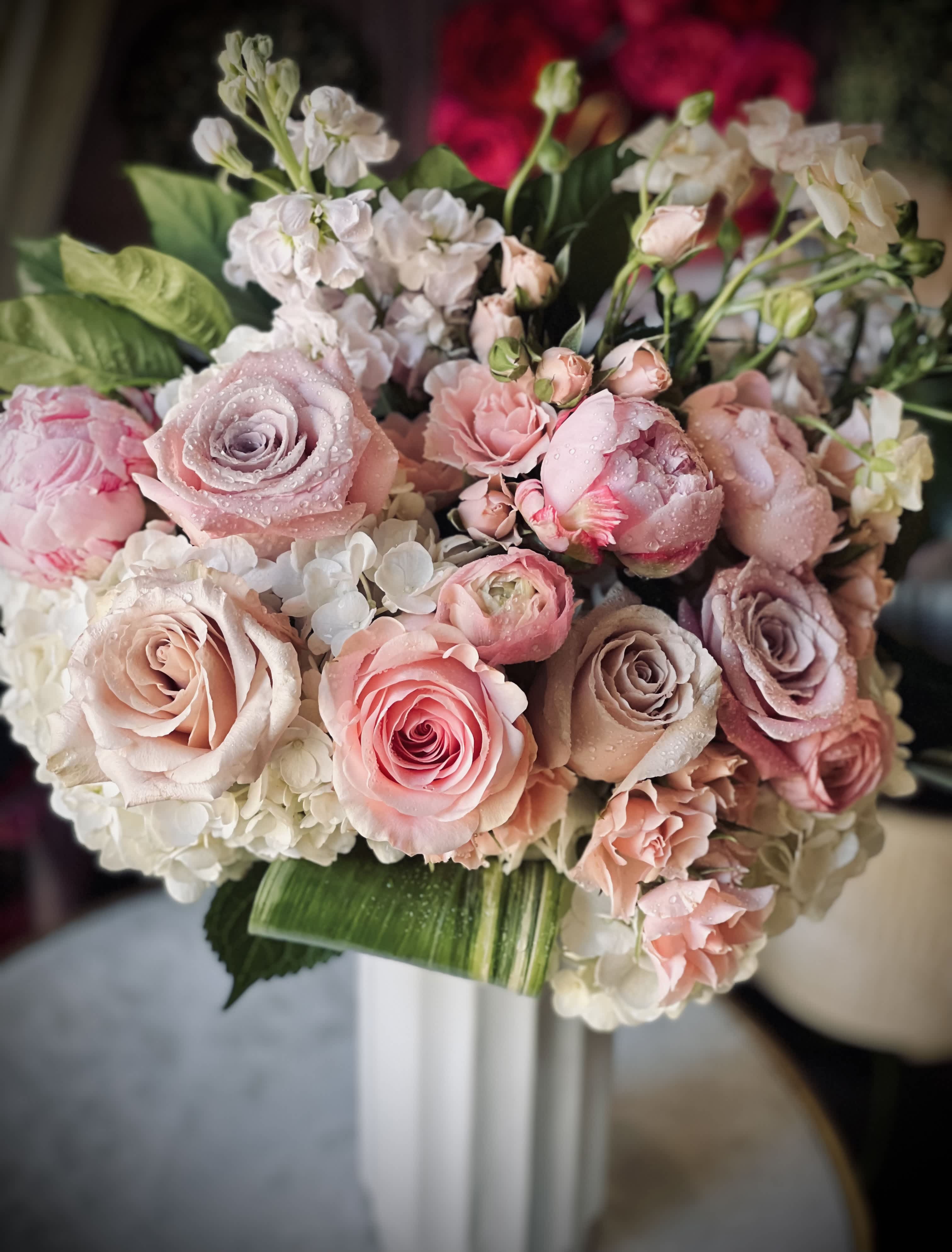 Celestial Elegance - Introducing our exquisite blush-colored florals, gracefully arranged with pristine white blooms and lush greens, elegantly showcased in a timeless tall vase. Embrace the classic beauty that effortlessly enhances any space.  