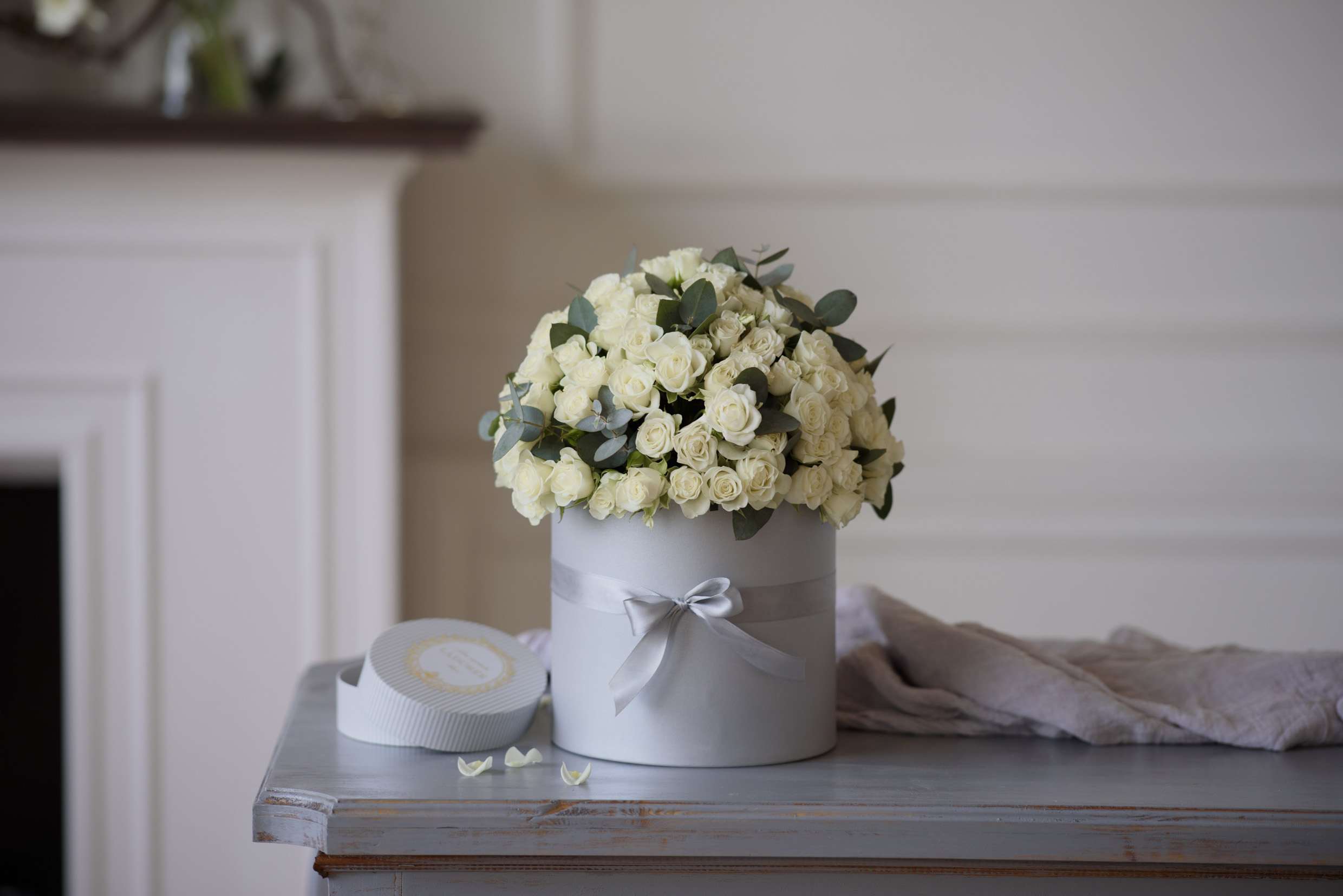 Augusta - The Augusta arrangement delivery includes: Premium light white spray roses 15 to 20 stems accented with eucalyptus (Color may vary) Care instructions Your custom message on our Luxe stationary Hat box size: D5.5H7&quot;