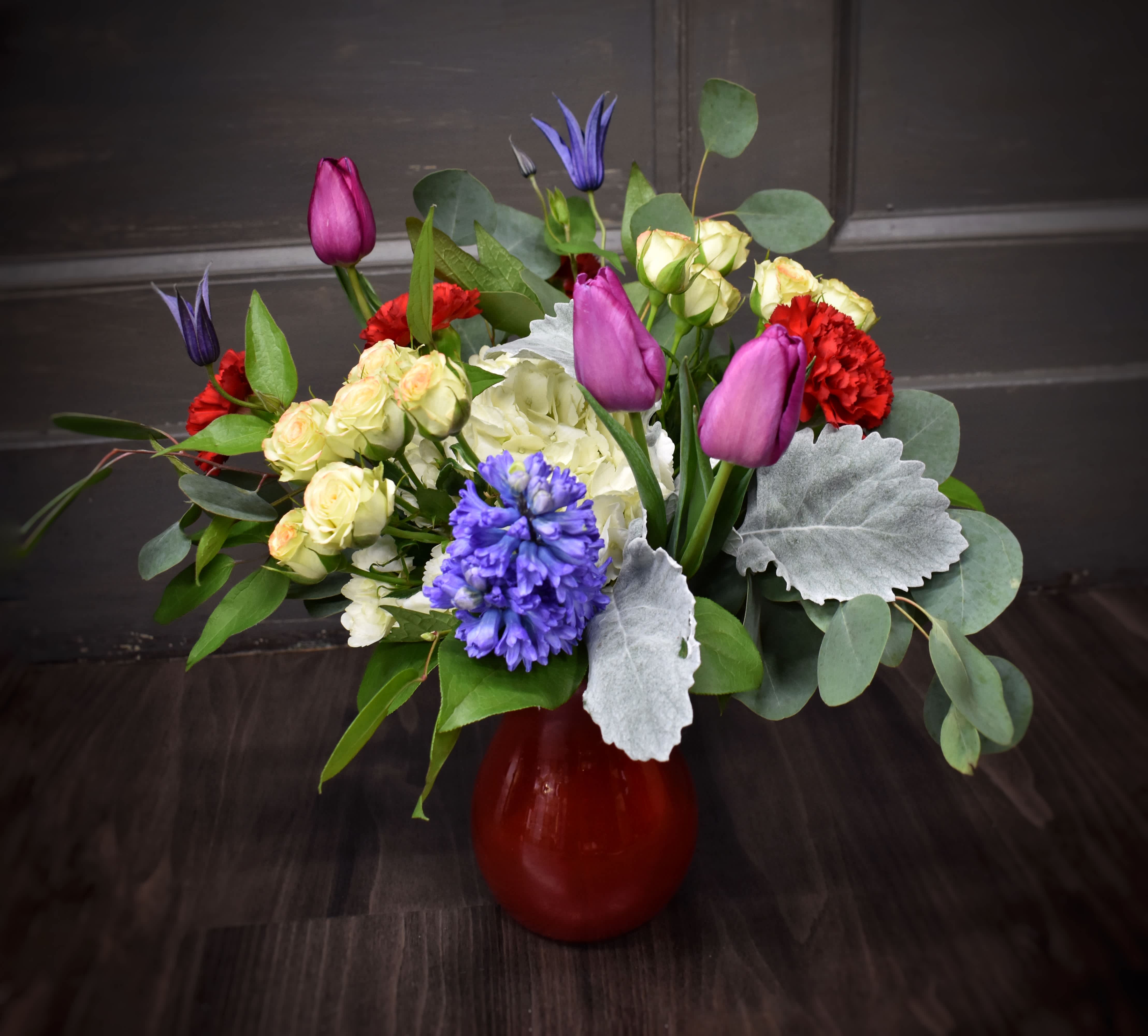 Cross My Heart - We love this colorful valentine bouquet! A bright red vase is filled with tulips, fragrant hyacinth, spring clematis, hydrangea, spray roses and carnations.