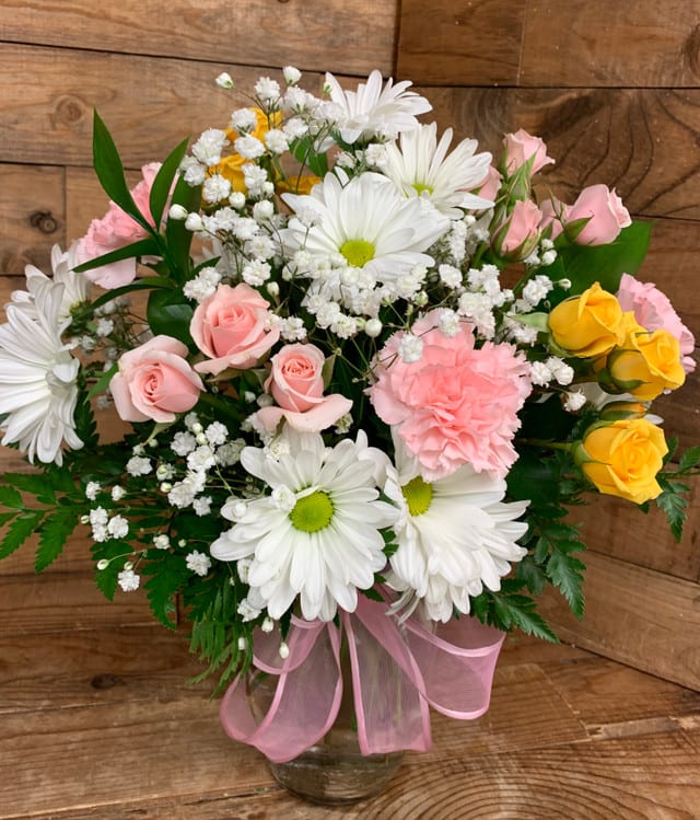 Pink Lemonade - A light and lovely bouquet that’s sure to catch their attention with colorful fresh blooms that say thanks, congratulations, or just thinking of you. Arrangement includes pink carnations, white daisies, pink and yellow spray roses, baby’s breath, and greenery. 