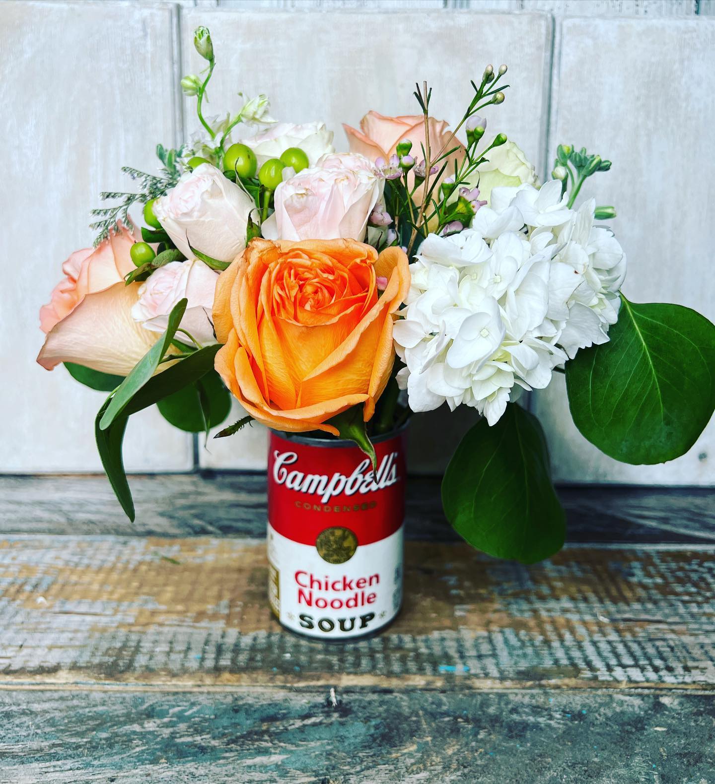 Get Well with a Cup of Soup  - Send a comforting touch with our perfect get well gift – a can of chicken soup filled with beautiful fresh seasonal flowers. This thoughtful gesture is sure to convey your wishes for a speedy recovery and bring a warm smile to that special someone's face. A unique and heartwarming way to show you care during their healing journey.